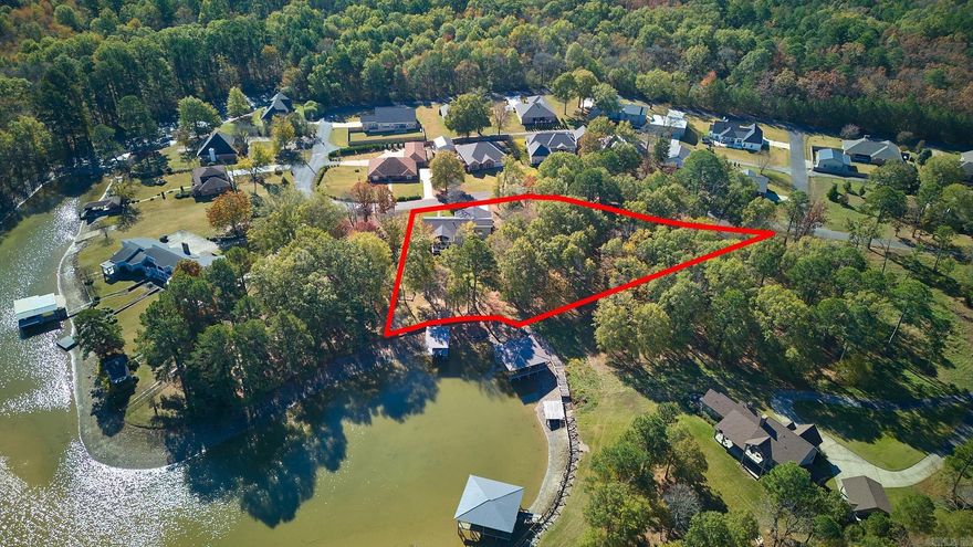 Welcome to your Lake Hamilton home in Hot Springs, Arkansas! In highly sought-after Caroline Acres, this freshly renovated 3-bedroom, 2-bath brick ranch-style house is situated on a double lot spanning 1.58 acres, providing you with the ultimate in privacy and space. You'll be captivated by the elegance of the 3/4" white oak floors that flow throughout the home. The heart of this home is the inviting living room, complete with a cozy fireplace featuring gas logs, perfect for those chilly evenings. The kitchen boasts a gas range, double wall ovens, and a sizable walk-in pantry. Whether you're cooking for a crowd or preparing a quiet meal, this kitchen has it all, including a breakfast bar for casual dining. Primary suite with a large shower and a luxurious soaking tub, and three closets. Two guest bedrooms and a study provide plenty of space for family and guests. This one-story gem is designed for comfort and convenience, with smart thermostat and insulated windows to keep energy costs in check year-round. Plenty of storage can be found both inside the house and underneath, making organization a breeze. Enjoy lake views from the deck, with covered boat dock and sea wall nearby.