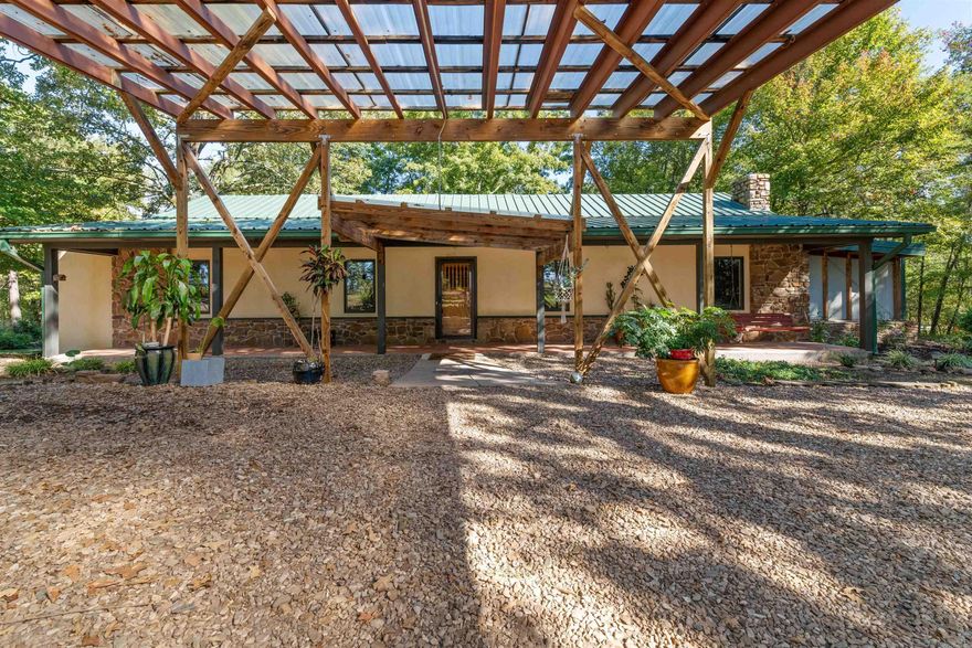 Beautiful home that is Architecturally designed+Custom Built! 2 miles from Wye Mountain! Large Den w/Cathedral Ceiling, fireplace,+stunning bamboo floors! Awesome kitchen that is loaded w/cabinets, lots of counter top space and built ins for decor! Fabulous Indoor Lap Pool! Master bedroom is surrounded by large windows, overlooking private, peaceful land. Master Bath has a Kohler Steam Shower! Spacious Library/bedroom- could be made in to 2 rooms, if needed. Windows galore in this home! Other features are: Almost all new plumbing through out home! New Insulation in the Attic! 2 Wood burning Fireplaces! Washer, Dryer+Refrigerator all convey(fridge is 2 years new) Approx. 30x44 Barn/Shop on its own electric, water+ Propane hookup. Small shed w/covered porch, well water and electricity!  Enjoy the Seasonal creek! All this on 5.30 acres!! Birdwatchers Dream property and Plant lovers too! Just 20 minutes from Cantrell/Chenal, 20 minutes from Conway, 40 to NLR...Come see this Unique,one of a kind Home!! It is Stunning!!Sellers will credit buyers $10,000.00 towards Pool Heater and heated floors on master end, and/or any  of buyers personal upgrades!