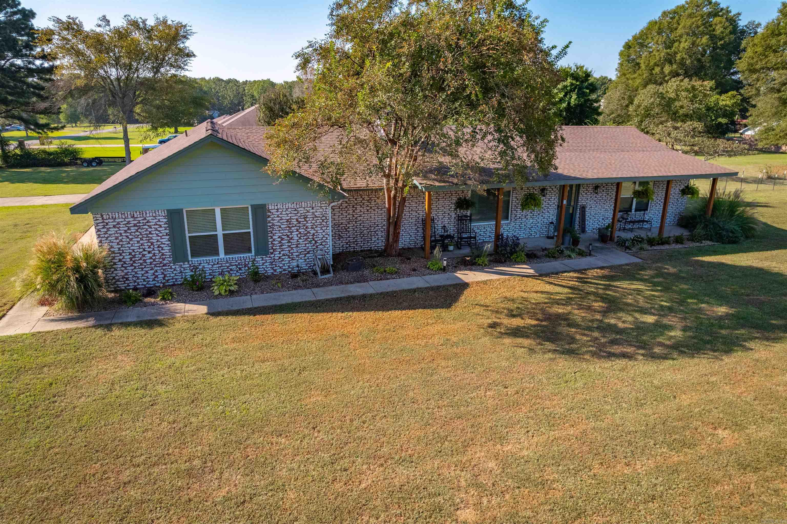 You will want to see this stunner of a remodel! 3-Bed, 2.5-Bath, 1-Pantry, 1-Office, 1-Bonus Detached Bunkhouse w/Power & Water -- with style for days! Oh, yes, this home sits on approx 1.57 acres and has Hwy 321 frontage! Roof was replaced in 2019, updated and remodeled in 2023 & 2024 such as new sheetrock in all living spaces, new paint entire home, new lighting fixtures & switches in the home, LVP flooring throughout the home, all new Low 3 windows, new heat pump HVAC & water heater 2016, all new kitchen appliances, and much, much more! The home boasts a split floorplan w/ an ultra open concept creating a kitchen, dining, & living combo for a massively open feel. Office and Master bed & bath are on the right of the home with Guest bed & bath on the left side of the home. 1/2 bath is off the kitchen and the home also has a nicely sized laundry space too! Outside is the front and rear porch areas, large yard, RV parking area w/electrical hook up, bunkhouse and more! You will want to come checkout this cute home! See Agent Remarks.