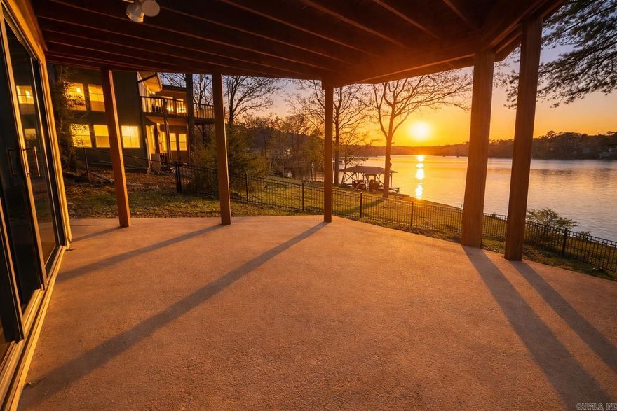 Lakefront opportunity on Lake Desoto—a premier ski lake—featuring over 100 feet of shoreline, private boat dock, and breathtaking open water views! Ideal for a vacation home, short-term rental investment, or peaceful retirement retreat.  Architecturally appealing inside and out, this spacious home offers 3 bedrooms, 3 baths, 2 living areas, a loft, and 2 bonus spaces plus a workshop/craft room for ultimate flexibility. The main level features a primary suite, expansive bonus room, and stunning lake views from the kitchen and living area. The lower level includes 2 bedrooms, full bath, and second living area—perfect for guests or multi-generational living.  Enjoy two large decks overlooking the water, ideal for entertaining or relaxing. Fenced backyard with rod iron fencing, 2-car garage, and circle drive add convenience. Located in amenity-rich Hot Springs Village with lakes, golf, and trails—this is lake living with strong investment potential!