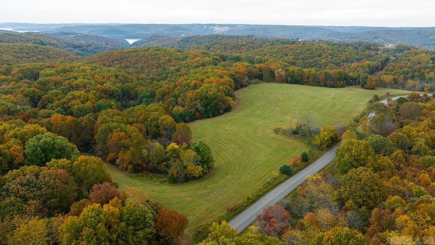 What a find! Loaded with options, features, and possibilities… few come along with all this tract has to offer. The land fronts the paved county road for just over ¼ mile. Electricity is available across a portion of the property. Several acres of quality established pasture quality hay ground lay along the flat near the road. Located just out of site is a metal shop with concrete floor and electric. This building could be used as storage, a workshop, or as a living space. The trail system takes you out through the magnific marketable hardwood timber across a massive ridgetop overlooking wooded hillsides and a valley on two sides. Numerous build sites would accommodate your dream home, vacation getaway, or rental. The wildlife is abundant, and the hunting on this tract has endless options for Whitetail Deer, Turkey, hogs, and many other small game. Table Rock Lake is just a few minutes down the paved county road, and there is access to a public boat launch near Cricket Creek Marina, Long Creek Marina, and Big Cedar Lodge. The area is prime for investments and developments alike, with the renowned Table Rock Lake right down the road, a quick drive from the famous Branson, MO.