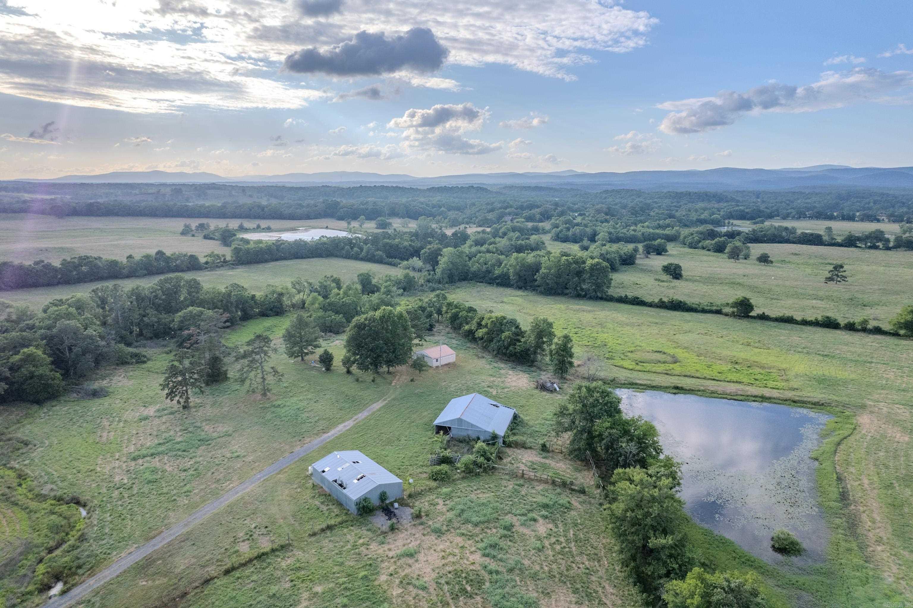 Escape it all on 40 gorgeous acres in the heart of the Ouachitas. Completely fenced with 2 ponds, multiple build sites, 2 barns, and expansive scenic views, this property is brimming with possibilities! Whether youāre looking for farm land, a private location for your getaway cabin, or a place to start a rental business, this prime location could be the spot! With easy access to ATV trails, swimming holes, and national forest, this property is perfectly located to enjoy everything that Polk County has to offer! Property has electric, well, and septic. Includes a historic old cabin that is unliveable but brimming with history. There is a 30x30 all metal building that has concrete floors, electricity, window ac, and a front entry door. The property also includes in a large metal 30x50 shop with electric and concrete floors, and 2 wide sliding doors. Don't miss your chance to own acreage in this highly sought after area!
