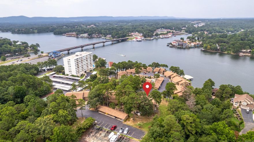 WALK IN LEVEL, two bedroom, two bath condo with all the amenities.  Cedar Crest is a gated, friendly community with an attentive POA board to provide peace of mind and the very best of condo living.  With gorgeous mountain and lake views, unit O2 sits at the top of the hill with one assigned carport space and plenty of visitor parking. The clubhouse, large pool and hot tub are a short walking distance from the unit.  New gutters and exterior paint on every building, and new boat dock roofs all is 2025.  All new roofing in 2023.   Six month minimum for rentals.