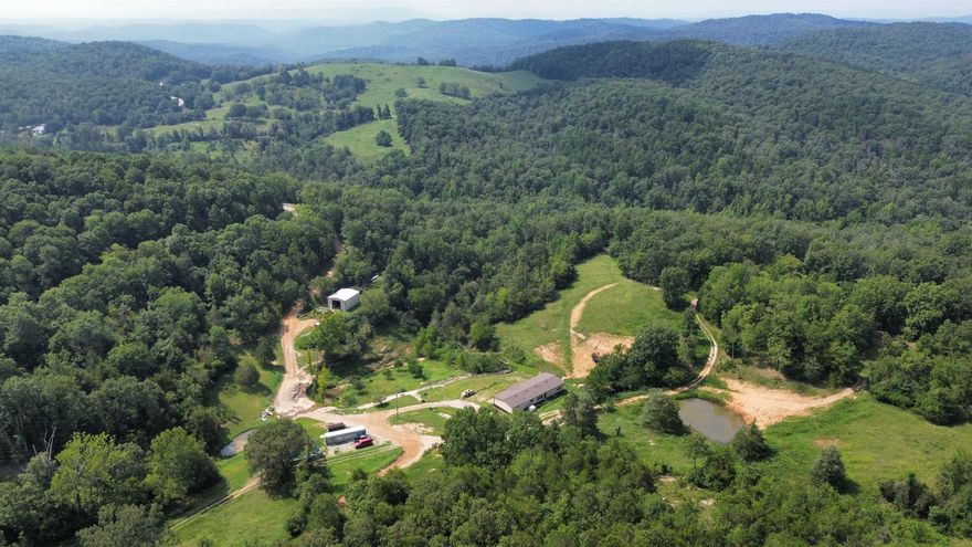 PRICE REDUCTION:ARKANSAS SEVEN SPRINGS RANCH This large acreage property is the ultimate get-a-way, with a combination of pasture, woods, & mountain views. It is tucked out of sight in a hollow. There is year round water. This includes 7 springs. 1 spring creates a beautiful waterfall, leading into a creek that runs throughout. 2 of the springs have been used for gravity flow water in the past. Additionally, there is a drilled well, 4 ponds, & trails.  There is an orchard, with the following fruit trees: apple, peach, fig, cherry, nectarines, as well as grape vines & a blackberry bush.   There is also a newer metal storage building & equipment building with a concrete floor, stubbed out for a bath & sink.  It is loaded with deer, turkey & even black bear.  You will also find a modern 2021 manufactured home, featuring an open floor plan & spacious kitchen. Fiber optic high speed internet & satellite tv are wired & ready. This tract of land has one of the best views in North Arkansas. There is scenic Hwy 9 frontage. It's only minutes from the White River, less than 1 hour from Lake Norfork, & only 20 minutes from Mountain View, AR, famous for the Folk Center, music, and festivals.