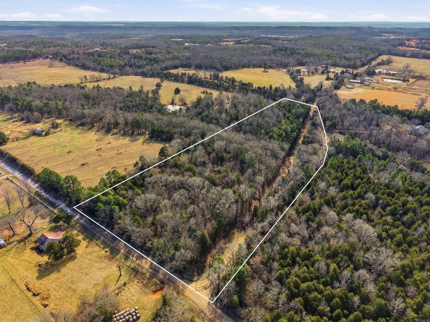 Beautiful approximately 10.55-acre wooded tract in Springfield, AR. This property offers county road frontage and a natural mix of mature hardwoods and cedar, creating privacy and a peaceful rural setting. A cleared path already runs into the property, making it easy to walk and explore potential building sites.  Gently rolling terrain provides multiple options for a homesite, cabin, or recreational retreat. There is a season creek on the property. Surrounded by pasture and larger tracts, you’ll enjoy wide skies, wooded views, and the quiet of country living while still being within a reasonable drive to Conway and Morrilton.  Wildlife is abundant, making this acreage ideal for hunting, outdoor recreation, or simply enjoying nature. Whether you are ready to build now or invest for the future, this 10.55 acres offers flexibility and opportunity in a beautiful Arkansas setting.  Per seller, city water is at the street.   Agent see remarks.