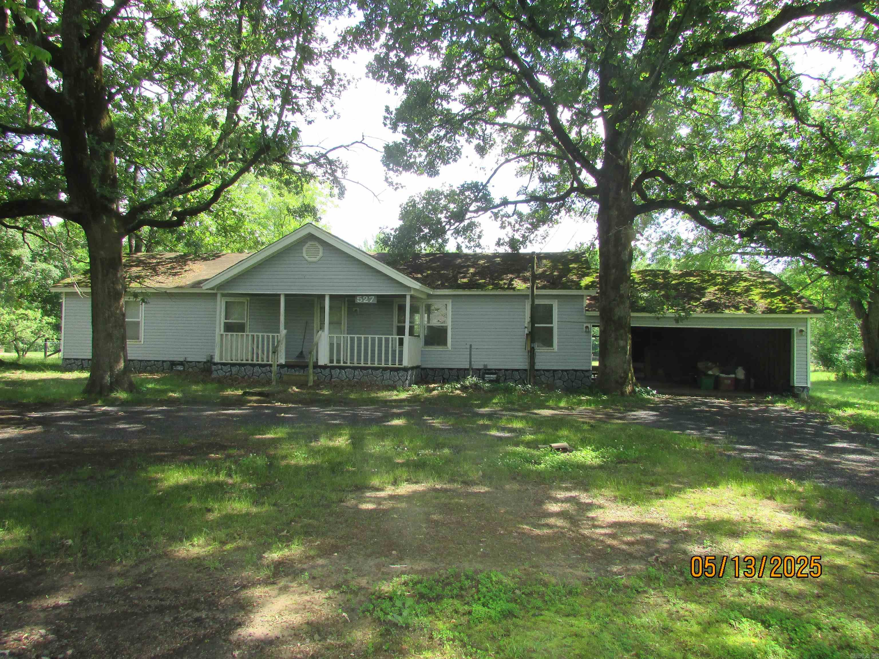 Looking for a project to fix up for yourself or for an investment? Here you go! THIS IS A MOBILE HOME. Great location. Seller has marked where the property will be divided off. Once surveyed, land should equal out to approx 1 acre. In house bank financing or cash only. It could possibly be a good flip as long as you follow the guidelines. The land is nice. This has a lot of potential with some work. There is a bonus room that can be used as a formal dining room or den/office. Open floor plan. 2 car garage. Building in front conveys but needs some work. Sold as is. **AGENTS SEE REMARKS**