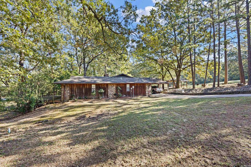 2500 E 8th St – Rare find in Danville! This 2,112 sq ft, 3 bedroom, 2 bathroom home sits on 26 acres inside the city limits, offering space, privacy, and convenience all in one property. Inside, you’ll find a beautiful rock fireplace, real cypress siding throughout, and plenty of character. The property also includes a 2-car carport, 15x37 ft storage barn, multiple garden spots, and a gazebo—perfect for outdoor living and hobbies. Recreation is right at your doorstep with the Peeler Gap Shooting Range just minutes away, plus quick access to the Ouachita National Forest, Petit Jean State Park, Mount Magazine, and Mount Nebo. Hunting, hiking, camping, and ATV adventures are all nearby. Danville also offers strong employment opportunities with several large industries close by!