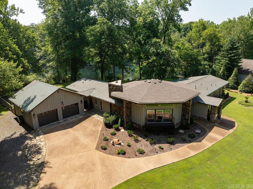 Stunning one-of-a-kind Little Red River home on THREE river lots with TWO boat docks. Uniquely designed to maximize river views from nearly every room, this river home features an open living, dining, and kitchen area with soaring 16 ft wood ceilings and a stone fireplace. Completely remodeled with custom finishes, the home includes stainless steel appliances, Durasein countertops, a wine cooler, and an ice machine. Offering three full baths, two master suites, and a guest bedroom, this property is perfect for comfort and luxury. One end of the house offers a second master suite, providing guests with their own privacy or could be used as in-law quarters. The  Relax in the screened porch, entertain in multiple outdoor areas, or enjoy the river from one of the covered boat docks. The backyard is beautifully terraced and maintained with vibrant flowers and lush grass, creating a picturesque riverside escape.