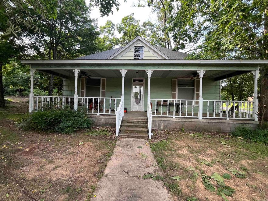Large Home corner lot built 1898! Offers opportunity for investors, or someone in need of a project. Home has a den with woodburning insert fireplace, large kitchen, formal dining room, formal living room, 3 bedrooms,  2 bathrooms downstairs also a large entry-way with staircase that leads to a full size room upstairs suitable for game room, bonus room or a 4th bedroom. A Large front porch  faces the south, large magnolia tree and several pecan trees on the property. The front of property has sidewalk and steps that lead to the street with a rock stonewall (owner states that was built in 1926). Property offers a large carport with storage shed under the carport. Property has metal siding, as well as a side porch that includes a wooden swing for enjoyment. Seller is selling property AS IS will not make any repairs. See Agent Remarks