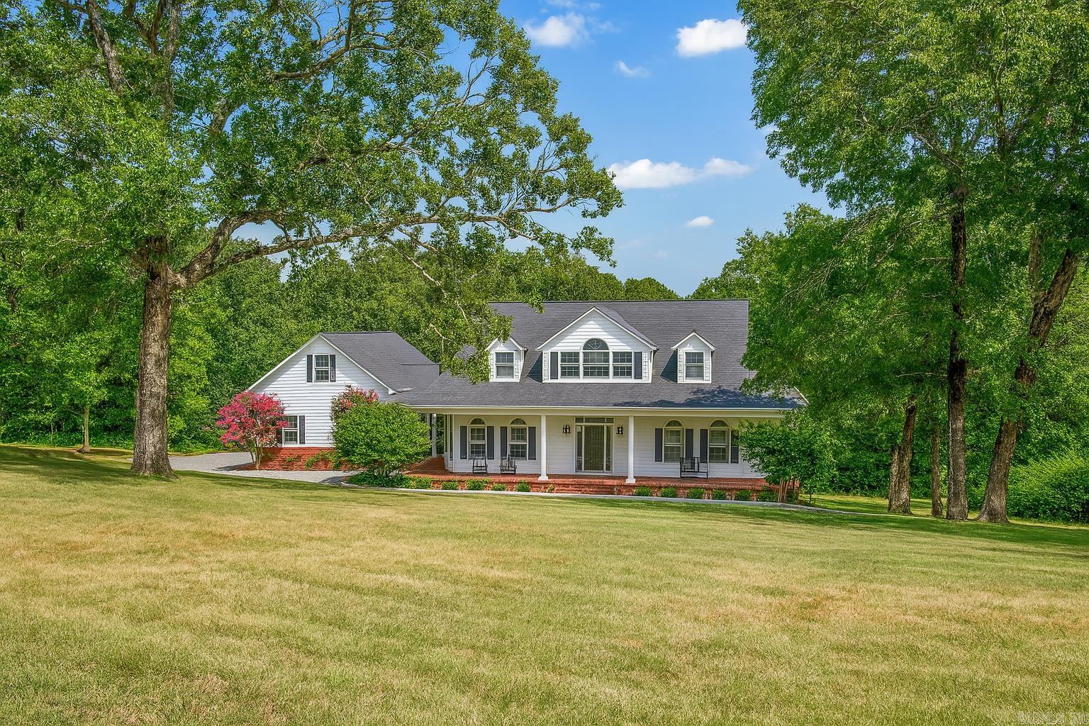 Beautifully updated 4-bedroom, 2.5-bath home on 5 mostly wooded acres in West Conway. This 2,500 sq ft home features an open-concept living, dining, and kitchen area perfect for entertaining. Fully remodeled in 2017 with recent upgrades including a new roof (2020), new HVAC, updated kitchen with custom cabinets and stainless appliances, and a spacious primary suite with walk-in tile shower and dual vanity. Guest baths have modern finishes, and the laundry room includes storage and cabinetry. Outdoor features include a newly built rear deck, retaining wall, flower beds, pavers, and a wraparound front porch. All-electric with private well and septic. Oversized driveway and a detached 2-car garage provide ample parking. Enjoy peaceful country living just 5 minutes from Walmart, restaurants, and everything Conway has to offer. Move-in ready and ideal for those seeking privacy without sacrificing convenience. Schedule your private showing today.