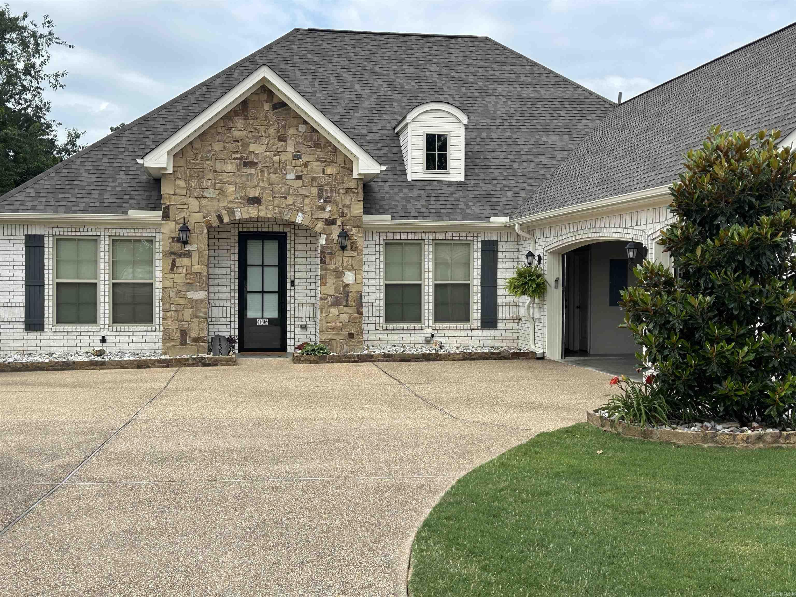 Welcome to 135 Callaway Circle, a beautiful 3BR/2BA home in Hot Springs' desirable Glencairn neighborhood. With 2,088 sq ft on a .38-acre lot, this home features an open floor plan, elegant white brick and stone exterior, and a 3-car side-load garage. Inside, enjoy a chef’s kitchen with gas cooktop, double ovens, island, walk-in pantry, and breakfast nook. The spacious primary suite includes a spa-like bath and walk-in closet with direct laundry access. Recent upgrades include a 2023 architectural roof and gutters, plus energy-efficient features like a tankless water heater and in-ground sprinkler system. Relax on the covered patio in the fully fenced backyard lined with magnolia trees. Glencairn offers walking paths, ponds, and a welcoming entrance—plus no rentals allowed, preserving its peaceful charm. Don’t miss your chance to call this stunning home yours!