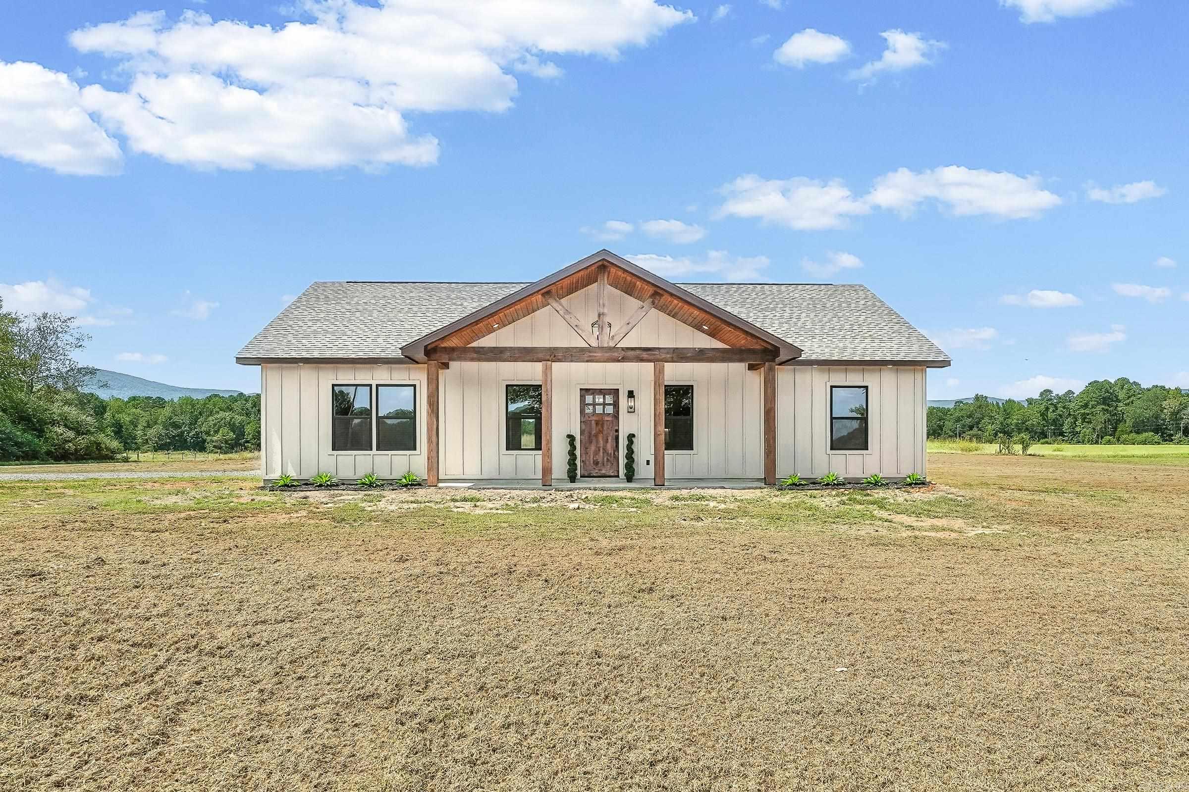 Beautiful New Construction home situated on 2.77 acres with serene mountain views and gorgeous pastureland! This property features 3 bedrooms, 2 bathrooms, open concept living and kitchen with a large laundry room and plenty of space! Upon entering you'll fall in love with the vaulted ceiling with custom woodworking ceiling and floor to ceiling stone fireplace with beautiful feature wall above the mantle. Throughout the home has durable luxury vinyl plank flooring, custom tiling in both bathrooms and stunning fixtures and lighting! The home is constructed with extremely durable board and batten siding and 30-year shingle roof! Attached is a double carport with plenty of parking and the perfect property for animals, space for kids to play, build your massive shop or whatever you may dream!
