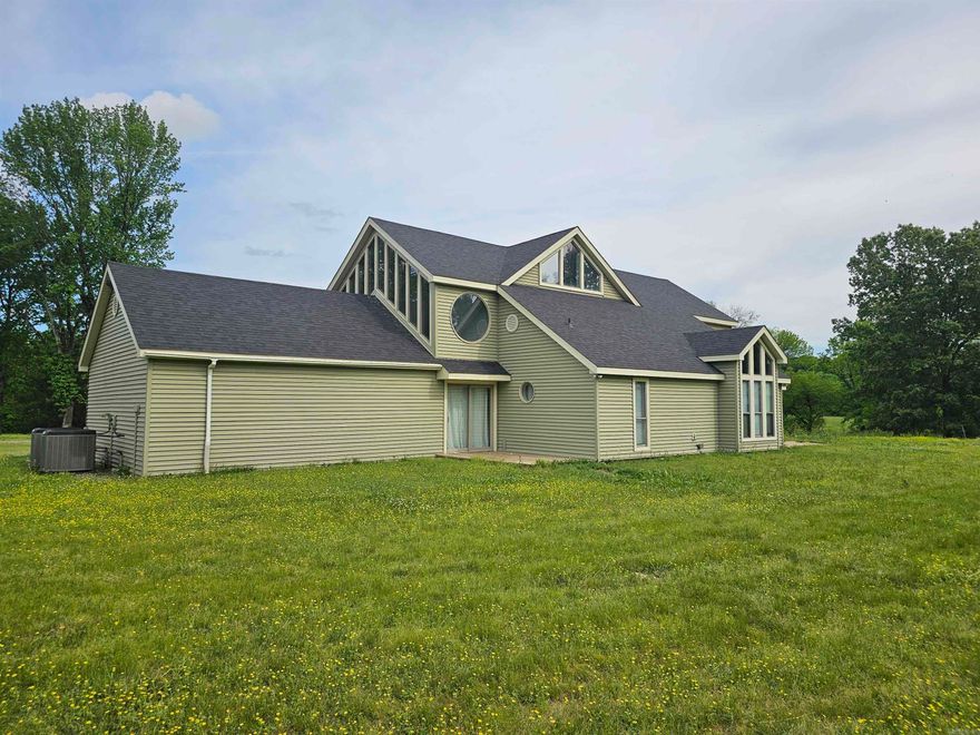 Welcome to this spacious and beautiful home nestled on 20+/- private acres, offering the perfect blend of elegance, comfort, and natural beauty. A picturesque tree-lined driveway sets the tone as you arrive at this serene retreat.  Step through the entryway and be greeted by a grand spiral staircase that leads to an expansive upper-level bedroom with a cozy sitting area and access to a private balcony.  The Great Room and dining area feature soaring vaulted ceilings, an abundance of natural light, and a charming wood-burning stove.  The gourmet kitchen is a chefās dream, boasting granite countertops, custom pull-out drawers, under-cabinet and recessed lighting, tile flooring, and premium finishes throughout.  Additional highlights include a 20x24 storage building with electricity and water, plus an additional storage building with electricityāperfect for tools, hobbies, or extra storage space. The home also features a double carport/cover.  Outside, you'll enjoy approximately 55 fruit-bearing trees and bushes, plus the 8,000 sq. ft. raised-bed gardens.  Whether you're looking for a retreat, a place to entertain, or your forever home, this property has it all.