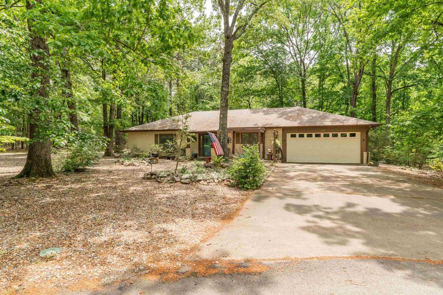 Welcome to 17 Castillo Lane--a beautifully updated all-brick home built in 1980, offering the perfect blend of classic character and modern comfort.  From the moment you arrive, you will appreciate the large front yard and the timeless curb appeal. Inside, you will find a warm and inviting interior featuring wainscoting ceilings in the living room, kitchen and bedrooms, along with newer luxury vinyl plank throughout and fresh carpet in the two bedrooms. The stunning gas fireplace with custom mantel creates a cozy focal point, while the kitchen shines with quartz countertops. 2 comfortable bedrooms are complemented by a BONUS ROOM  perfect as a 3rd bedroom or flex space- complete with its own mini split and closet.   The  home has newer plumbing, water heater, soaker tub, gutter covers. Step outside to your private oasis-back with a gazebo overlooking a serene, wooded backyard, plus an outdoor shower with pet wash too. A spacious 2 car garage rounds out this fantastic package.