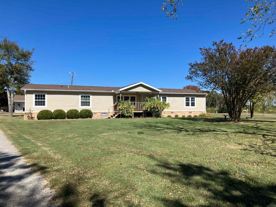 Looking for spacious living outside of city limits? This 2432 sq. ft. home was manufactured in 2000 and set on a permanent foundation on 1.80 acres of country land. The home has 5 bedrooms, 3 baths, and a large kitchen and living area perfect for entertaining or just relaxing in front of the fireplace. The master suite features a large private bath with an oversized garden tub, walk in shower and double vanity.  The property also has a storm shelter and shop building with overhead door.  Come tour this amazing property today!