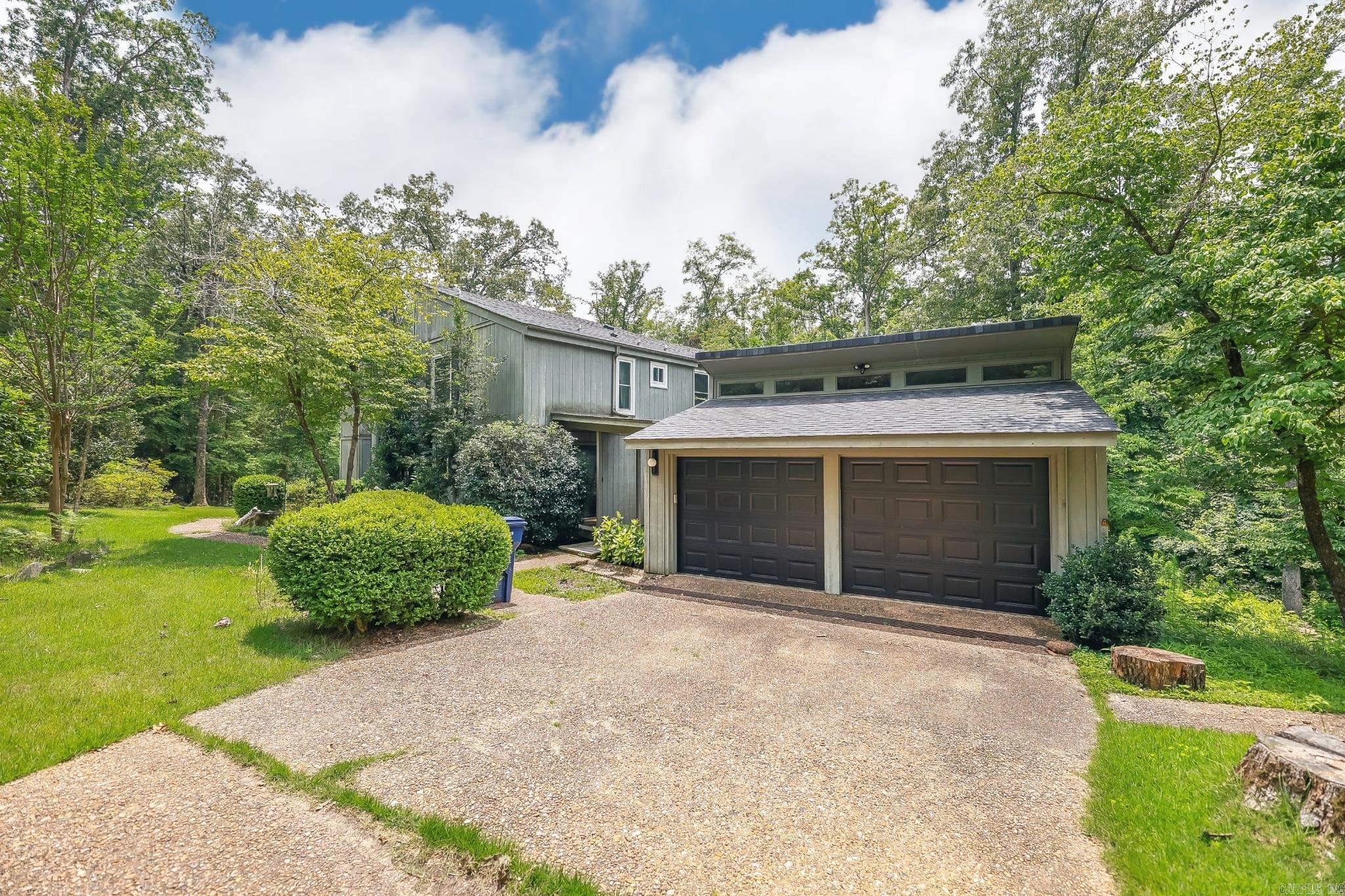 Looking for space, style, and privacy? This large midcentury home sits on almost 5 peaceful, wooded acres with beautiful landscaping and versatile floor plan. With 4 bedrooms, a walk-out basement with extra den, and several bonus areas, thereās opportunity to curate the space to your needs. Inside, you'll find classic contemporary charmāgenerous windows, clean lines, two-story vaulted living room, and an atrium that brings in natural light and peaceful views. Itās the kind of home that feels connected to nature, while still offering comfort and function. The thoughtfully developed landscaping is balanced with views of mature trees, shady paths, and access to the back patio with easy access to the detached garage and storage building. The sellers installed a new roof and HVAC system in 2024, leaf filter gutters, and will transfer a lifetime window warranty at closing. This unique home gives you that perfect blend of serenity, style, and space in a sought-after location that feels like you're miles from the busy-ness of town with quick access to local amenities. Fridge, washer & dryer to convey with acceptable offer.