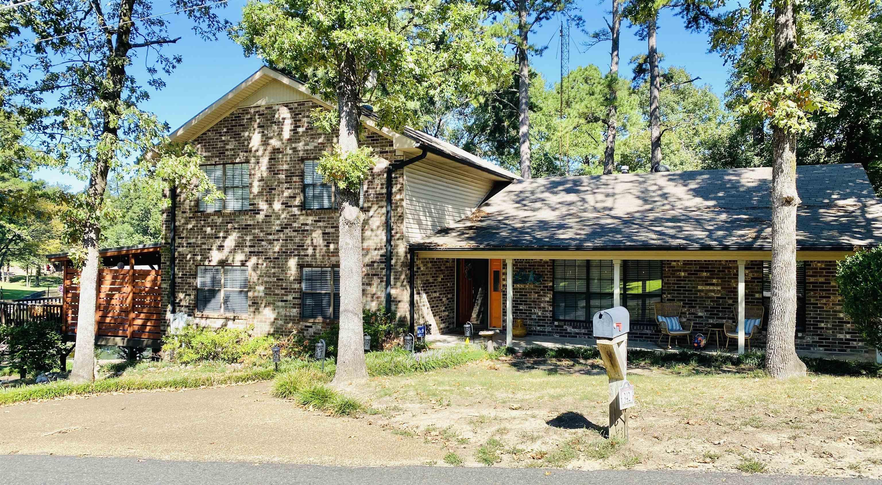 Step into this Lake Hamilton lake house and you will never know it was built in 1980. Sporting 2 master suites, 1 master suite up with a full bath and another one down with a full bath, a newly remodeled kitchen, 2 Large living areas, beautiful hardwood floors and outdoor living space that you'll never want to walk away from!!! Situated in a private cove just off the main channel with a boat dock and swim platform that can house all your water toys in your very own swimming hole. The Neighborhood "WOW"!!