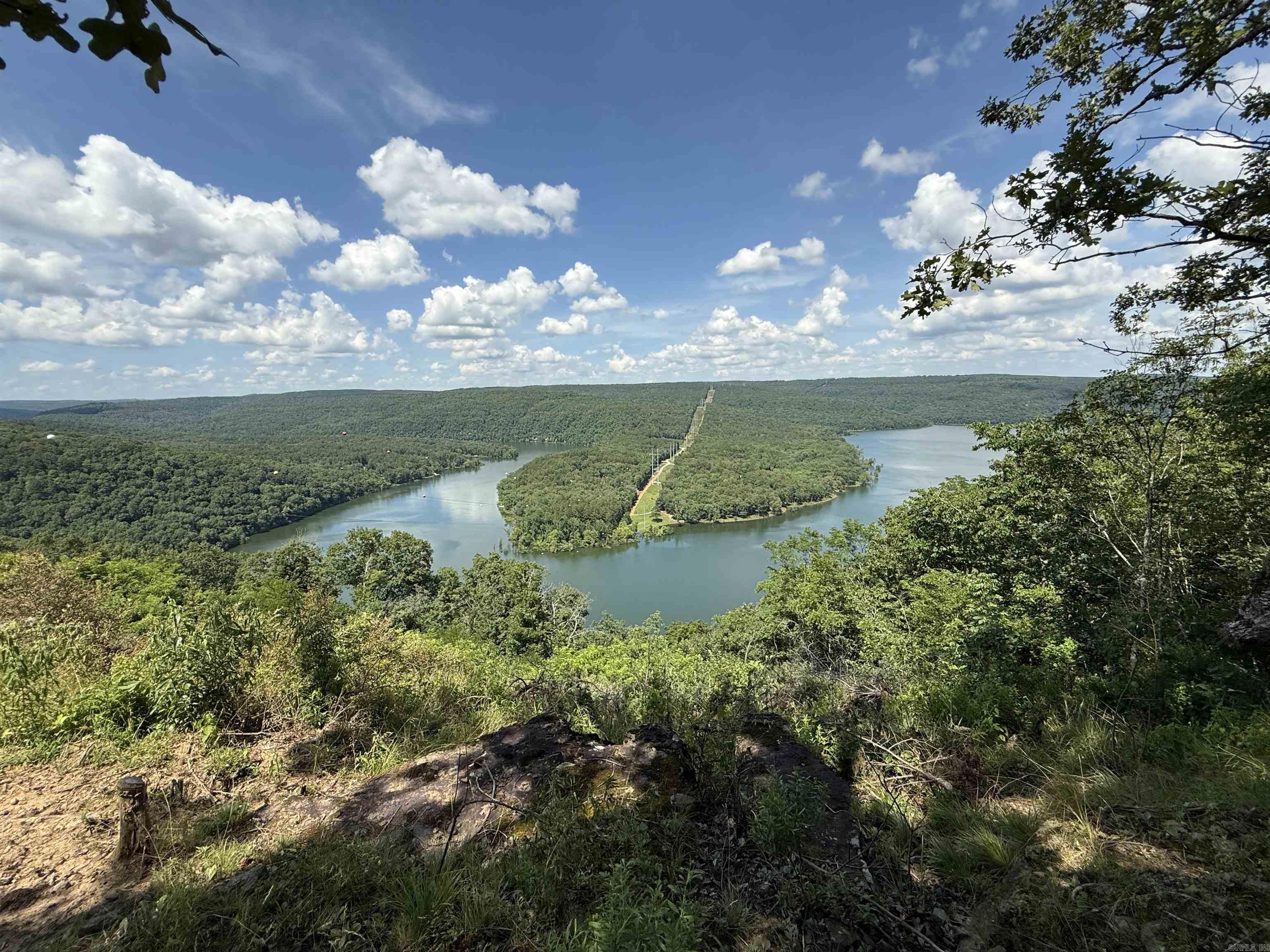 Amazing Views of Middle Fork on Greers Ferry Lake! Long Lot where you can tuck your home back off of the road and on the back side of the property that overlooks the lake. Lot 2 of Watersedge Estates Ph. I. (See covenants attached under "Docs"). Subdivision Lake Access (walking access, not a boat ramp) at the bottom of Lower Ridge Circle & ATV trails close by in Fairfield Bay. Fiberoptic Internet available at the road through "Connect2First" .