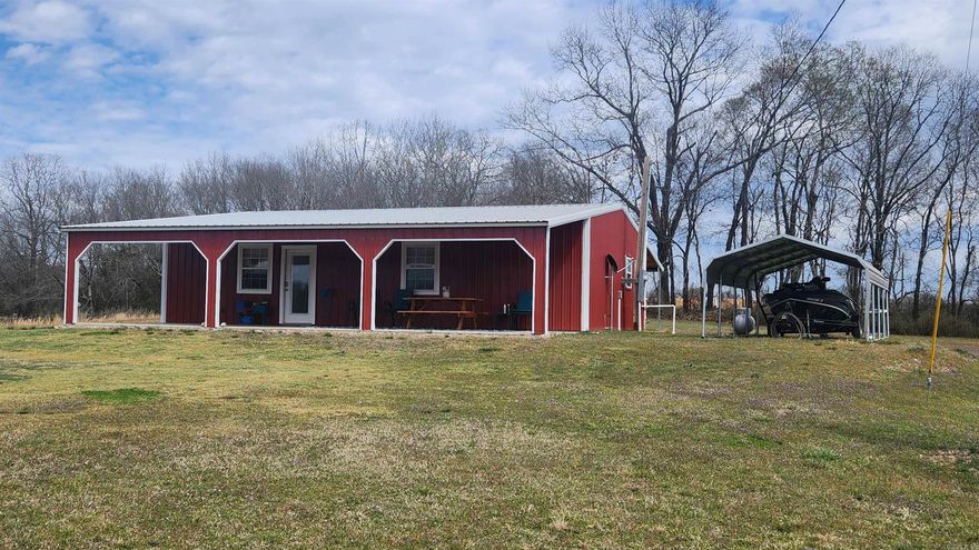 Built in 2021, this 1120 sq ft cabin is the perfect weekend getaway place. The metal building is 28x40 with two 12x40 covered porches. Spray insulation cover the ceilings for added protection. 12x20 boat shed is also a feature. All of this sets on 3.9 acres with a creek running along the south border. Nice mountain views. Well and septic. Inside features a large primary bedroom and walk-in closet. Guest bedroom features 4 built-in bunk beds. On-demand water heater for your endless supply of hot water. Comes mostly furnished. The rough-sawn lumber definitely gives it a cabin feel.  Currently used as a vacation rental.