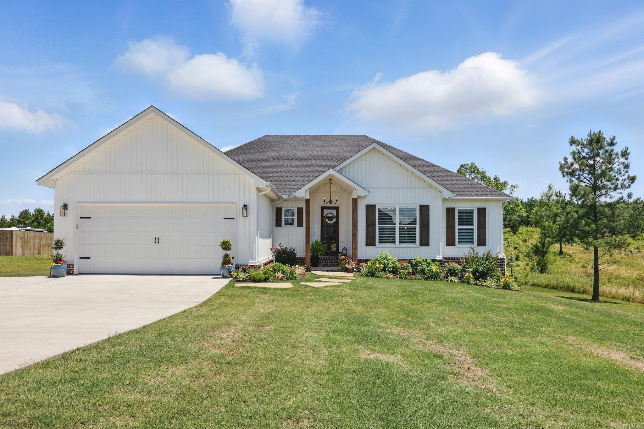 This beautifully maintained, like-new home sits on a spacious 1.86-acre lot and offers the perfect blend of modern comfort and peaceful living. Just one year old, this 4-bedroom, 2-bathroom home features an open-concept layout with stylish finishes throughout—including a designer kitchen with a large island, quartz countertops, and stainless steel appliances. Natural light pours in through large windows, offering views of the private, tree-lined backyard. Don't miss your chance to own a move-in ready home in a quiet, country setting—just minutes from town.