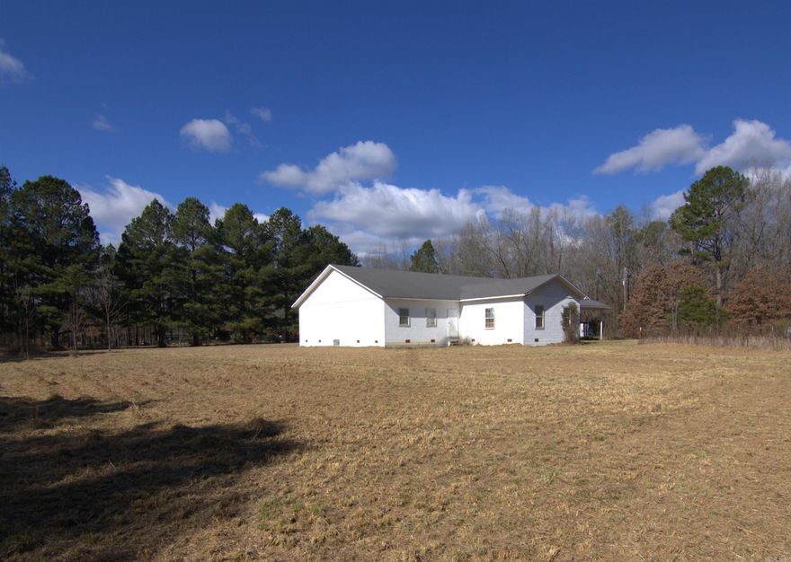 This property was built as a church but could have multiple uses.  It offers 2 1/2 baths and a full kitchen with a stove(working condition is unknown), refrigerator, freezer and sink.  There is a room with a vaulted ceiling that has served as a sanctuary.  There are two rooms off to the side that served as classrooms and one room in the front that was an office.  The building is in need of repair and is being sold as is.  The roof is roughly 16 years old.  Take a look at this property on 5 acres, close to West Little Rock.  You are only limited by your imagination. Property is being sold as is.