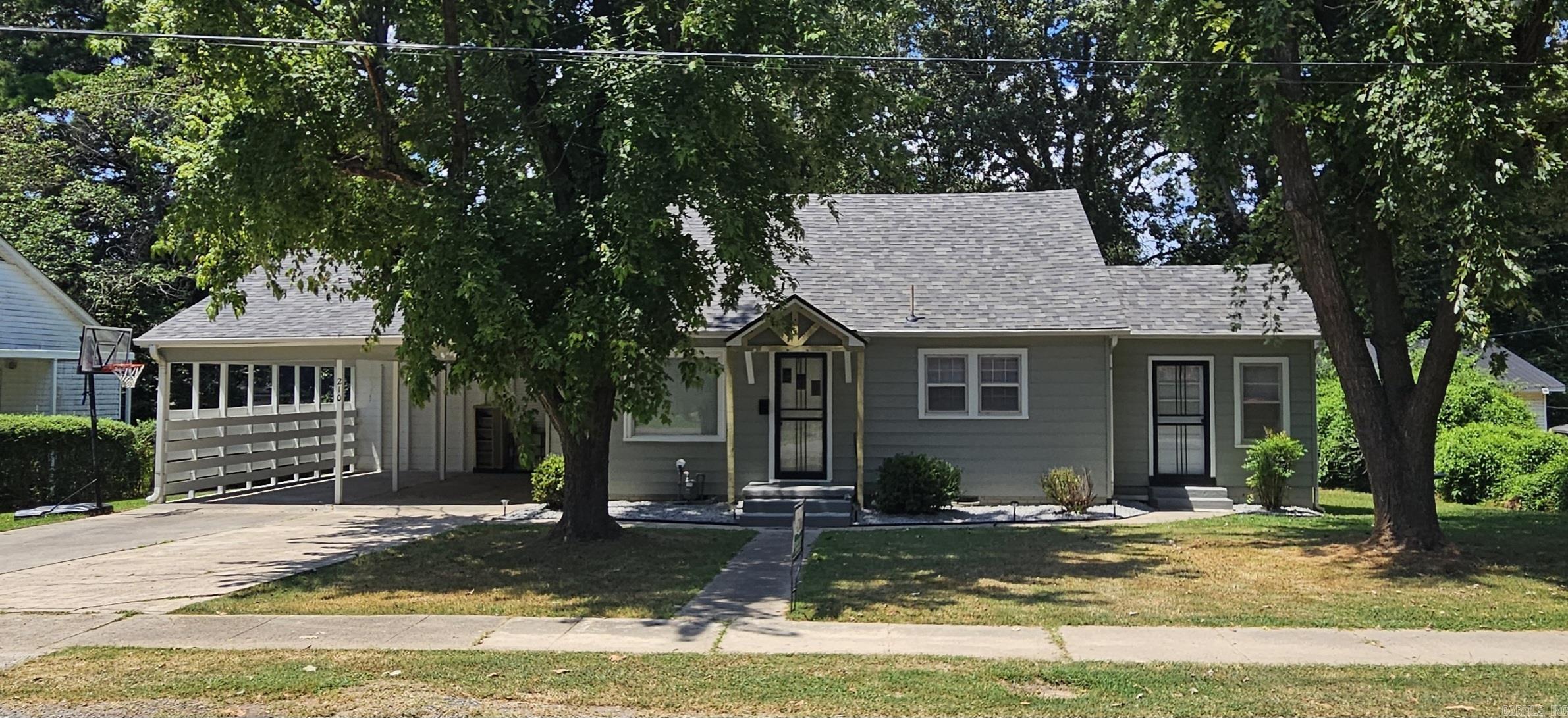 2/3 bedroom 1 bath home with a 2 car carport big enough for oversize automobiles. House has new roof , new electrical wiring, new central heat and air unit, new lighting, new faucets, home has a large floored attic space, painted inside and out. Original hardwood floors, wood walls throughout house, and new flooring coverings . Multi use room, could be a bedroom, could be a laundry room, or sun room. Solid home in an excellent neighborhood.