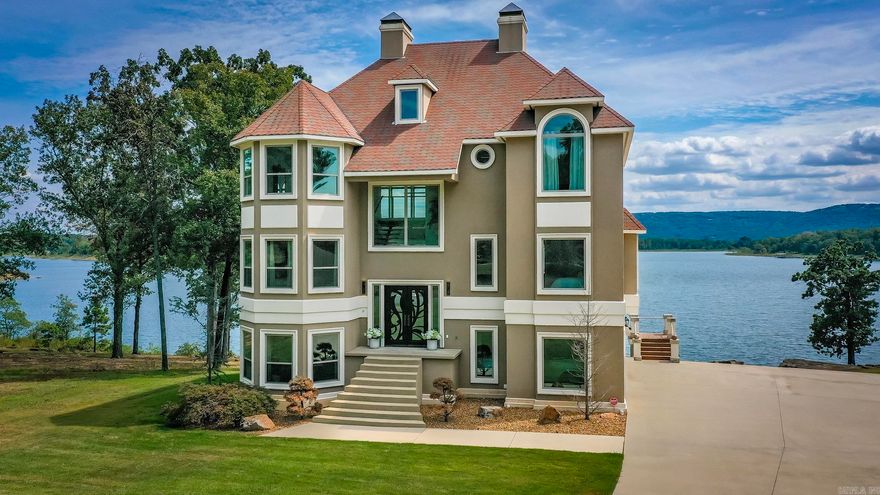 LAKEFRONT AND LAKEVIEW LUXURY LIKE NO OTHER - Prepare to be captivated by this extraordinary lakefront residence where architectural artistry meets the serene beauty of nature. Perfectly perched to maximize panoramic views, this home offers an unmatched blend of privacy, elegance, and front-row access to the water. From the moment you arrive, you're greeted by an endless blue horizon. Inside, walls of glass invite the lake in, flooding open concept living spaces with natural light and offering uninterrupted vistas. High-end finishes, soaring ceilings, and designer details create a sophisticated yet welcoming ambiance. Step outside to your private balcony on all three levels. Ideal for morning coffee, sunset dinners, or launching your kayak for a morning or afternoon on the water. Whether you're hosting guests or savoring a quiet retreat, this home offers spaces designed for connection and tranquility. This is not just a home--it's a lifestyle. A rare opportunity to own lakefront luxury that truly stands apart.