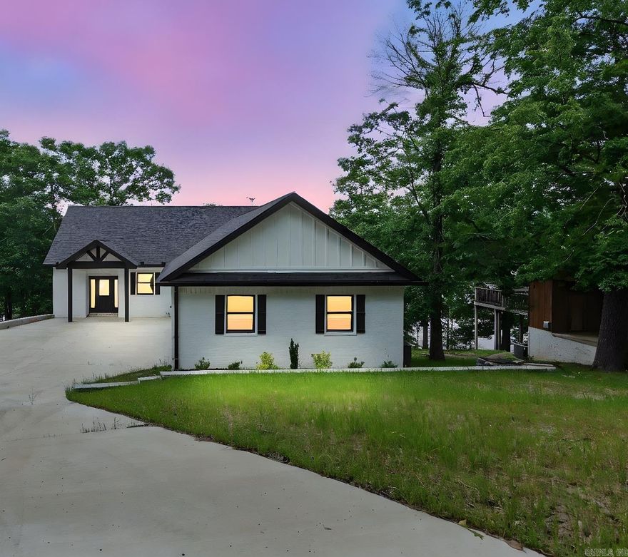COVERED BOAT DOCK is ready to store your boat for easy access to enjoy the lake this spring and summer. Beautiful home with gorgeous views of the lake from most every room has all the amenities you need to enjoy a relaxing summer while entertaining friends and family. Living areas on both floors open up to separate porch/balconies for plenty of space to entertain inside and outside. Main level has open concept living/kitchen/dining areas as well as the primary bedroom/bath, laundry room and 1/2 bath at entryway. Premium luxury vinyl plank flooring, quartz counter tops in the kitchen, granite in the other wet areas and a place to hang your bags, coats and other items as you enter the home from the garage. There is a large laundry/combination pantry located on the first floor, and a second living space with three bedrooms and two baths on the bottom floor. Short term rentals are allowed in this area as well. Call your agent or me today and let's get you started in owning the lake life!