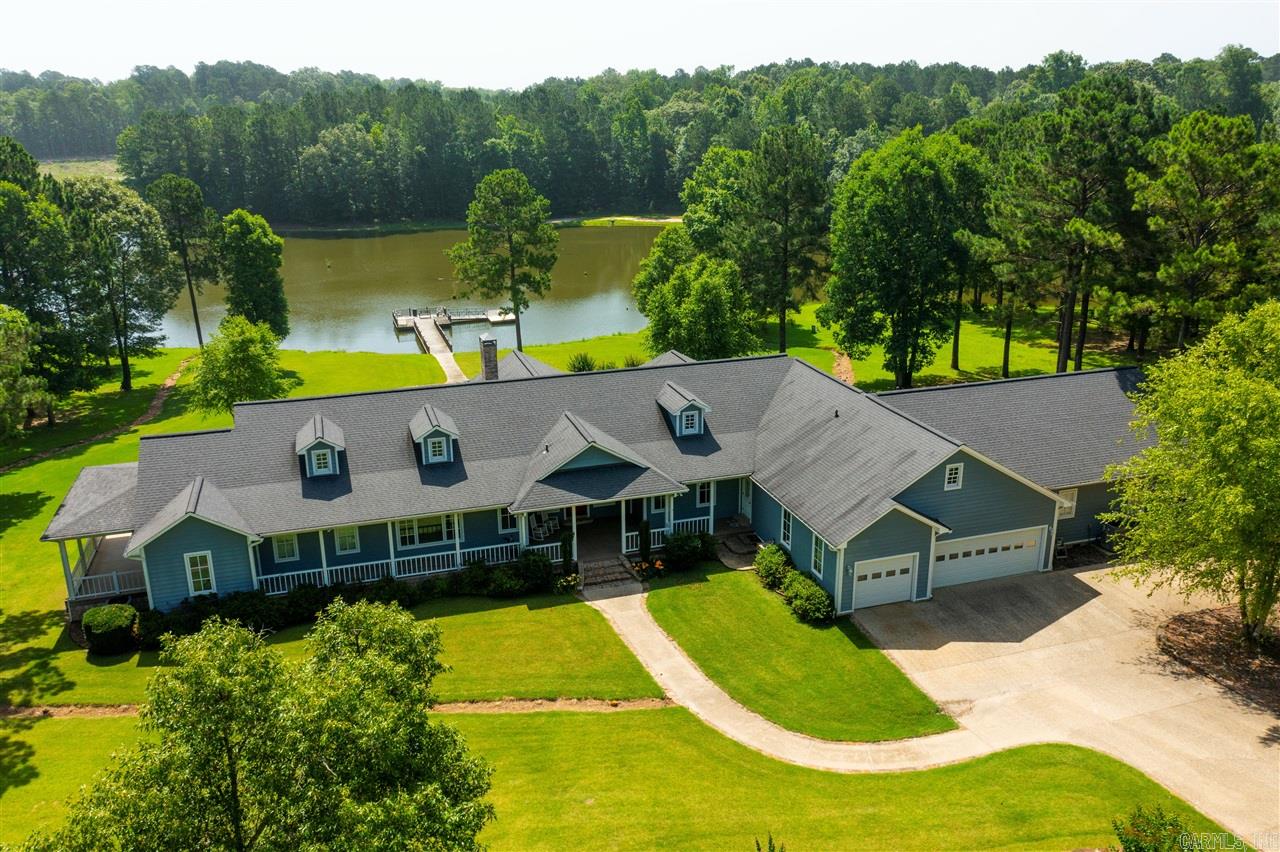 Click the external link below to tour this home now! Large, upscale, contemporary style home. Built in 2011 by Barry Cameron. Home is situated in both El Dorado and Parkers Chapel School Districts. Property includes 5213 square foot home, two-story detached matching shop and 5 Acre lake stocked with largemouth bass and bream. Home is surrounded by John Watson moonlight effect tree lighting with 55 light fixtures that enhance night time charm and security. Also included with the property is a 3 bedroom/2 bath 2005 manufactured home with a detached matching shop. This property sits on an additional 3 acres and is renter occupied.