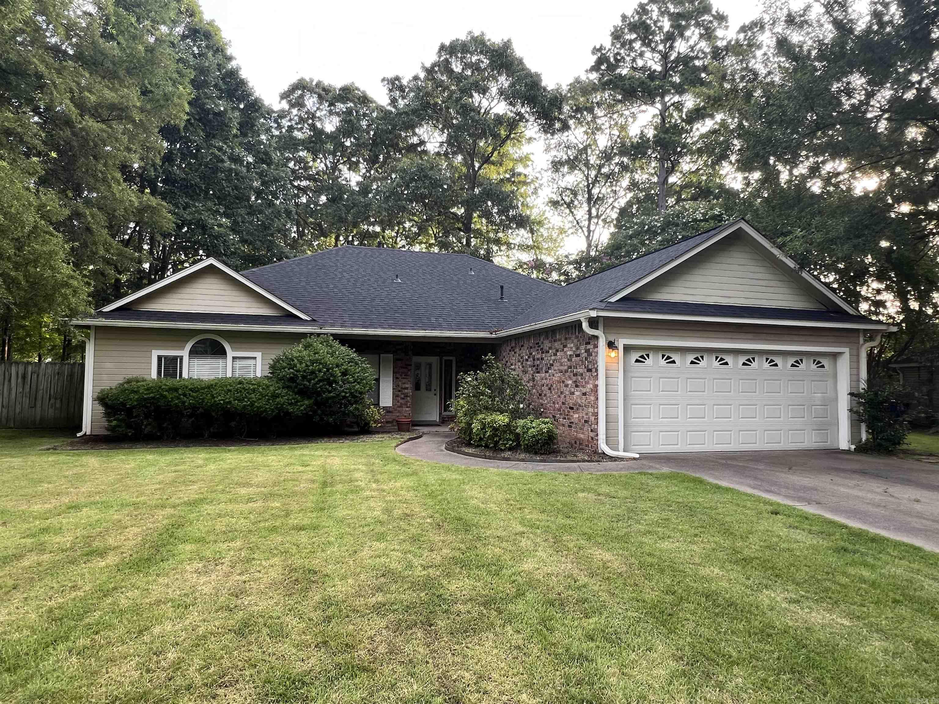Discover this charming one-level home located in the heart of Maumelle! This 3-bedroom, 2-bathroom residence boasts an inviting open floor plan and sits on a generously sized, level lot. Step into a warm and welcoming living space featuring a stunning rock fireplace mantel and a kitchen with a convenient breakfast bar—perfect for casual meals or entertaining. Unique touches like a stylish vanity in the guest bath and a distressed accent ceiling in the hallway add character throughout. Enjoy outdoor living with a fully fenced backyard, spacious covered patio, and an additional storage building for your convenience. Ideal as a starter home or a place to raise your family, this home is close to schools, shopping, and just a short golf cart drive for a relaxing round of golf. New Roof October 2024 Come see all the charm and comfort this home has to offer!
