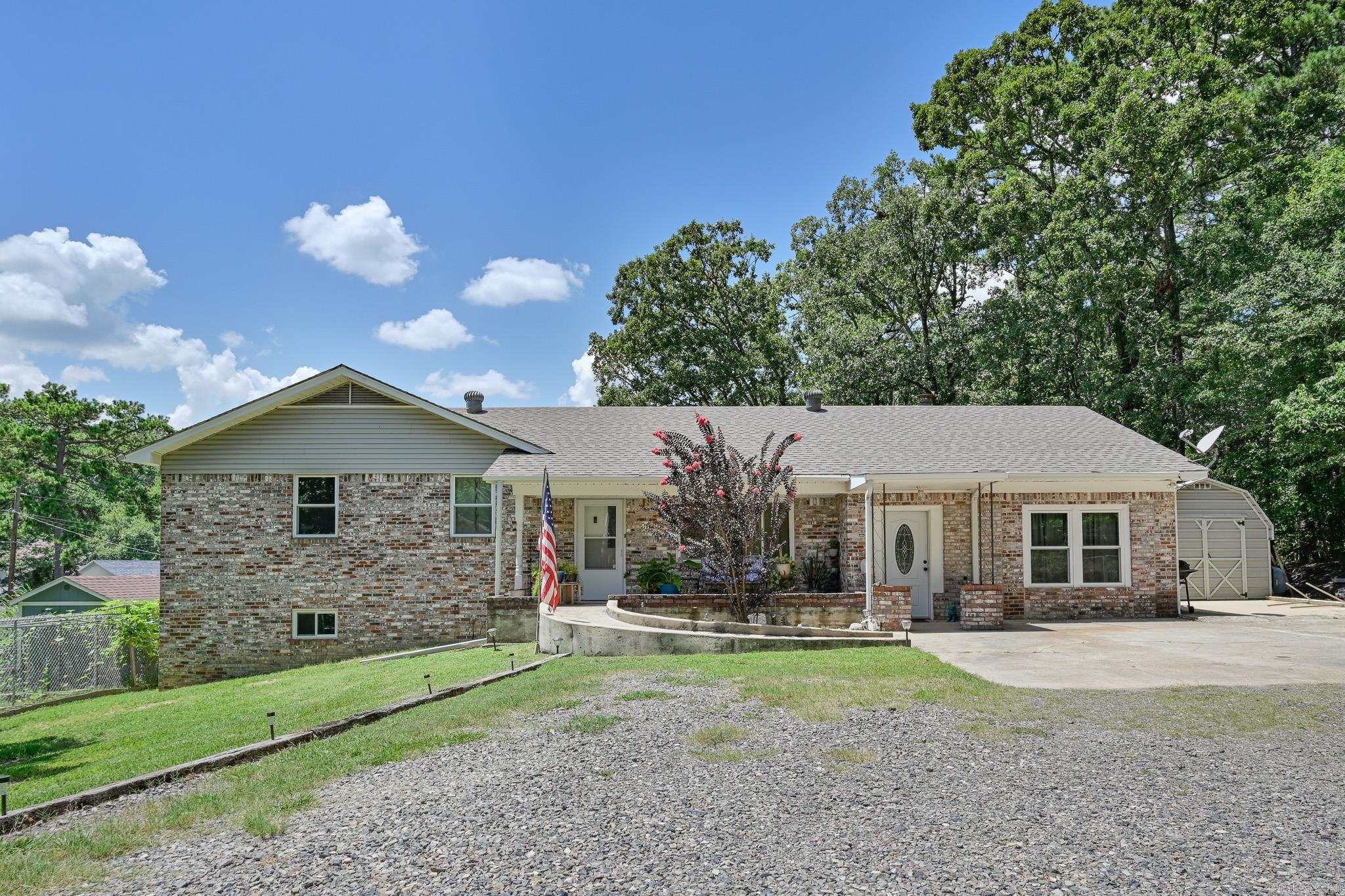 Updates galore! Beautifully painted throughout this SIX or SEVEN bedroom 3.5 bath home on 3/4 of an acre located in Mena, AR. THREE outbuildings, gazebo, chain link fencing, large shade trees, ornamental trees, concrete ramp leading to inside this amazing home. There is so much room inside - with a nursery beside the primary bedroom and an additional bedroom on this level along with 2 full bathrooms, main floor has 1 or 2 bedrooms and a half bath, large kitchen with a sitting room off the kitchen; downstairs has 3 bedrooms and 1 bath. The roof and new windows are less than 5 years old. Great neighborhood to raise a family. Agents see remarks.