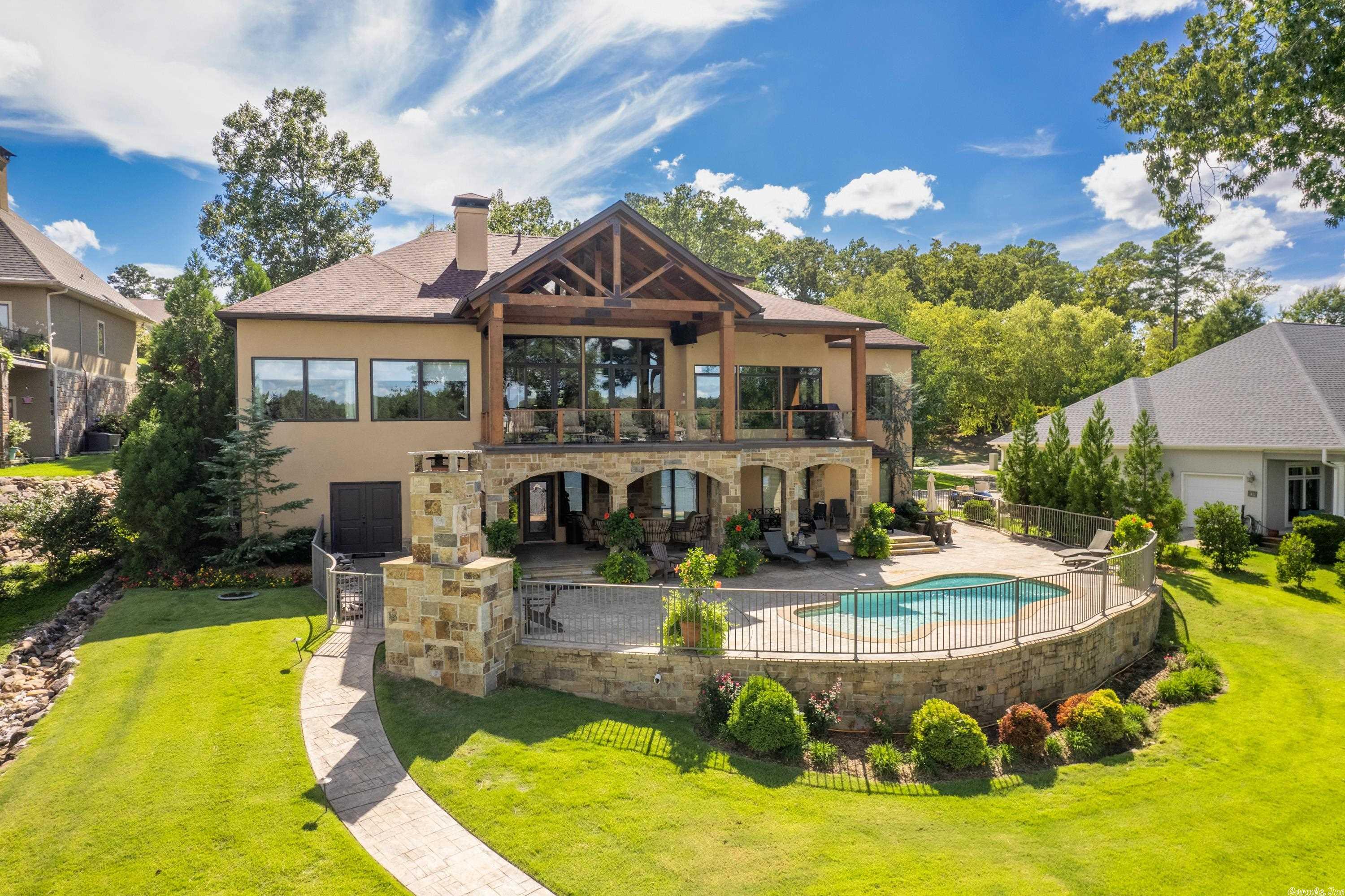 Exceptional, Tranquil and Distinctive! This outstanding lakefront home is timeless in design and achieves the rare blend of luxury with warmth and comfort! 6 bedrooms, 5.5 baths, almost 6,100 s.f. tucked away in natural surroundings of lush landscaping and stunning unobstructed water views! three living areas, three car garage, inground pool, bar room with half bath, outdoor kitchen and fireplace! You have to see this special offering to believe it! POA includes a private boat ramp and fenced storage