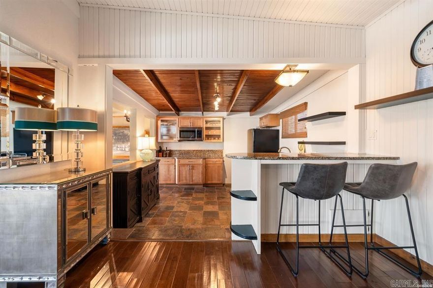 Nestled on the tranquil shores of the lake, this adorable 2-bedroom, 1-bath cottage offers the perfect blend of charm and functionality. Imagine waking up to million-dollar views right from your cozy retreat! Being sold fully furnished, this move-in-ready gem is thoughtfully designed to make lake living as seamless as possible. Step outside, and you’ll find your very own covered boat dock with lift, ideal for your watercraft, plus a swim dock for sun-soaked afternoons by the water. The seawall ensures durability, while the fenced yard adds privacy and space for family, pets, or entertaining guests. Whether you're relaxing at the waterside gazebo, enjoying the picturesque scenery, or making memories out on the lake, this home is as cute and inviting as it gets.  Don’t miss out on this rare lakeside treasure—it’s a little slice of paradise waiting for you!