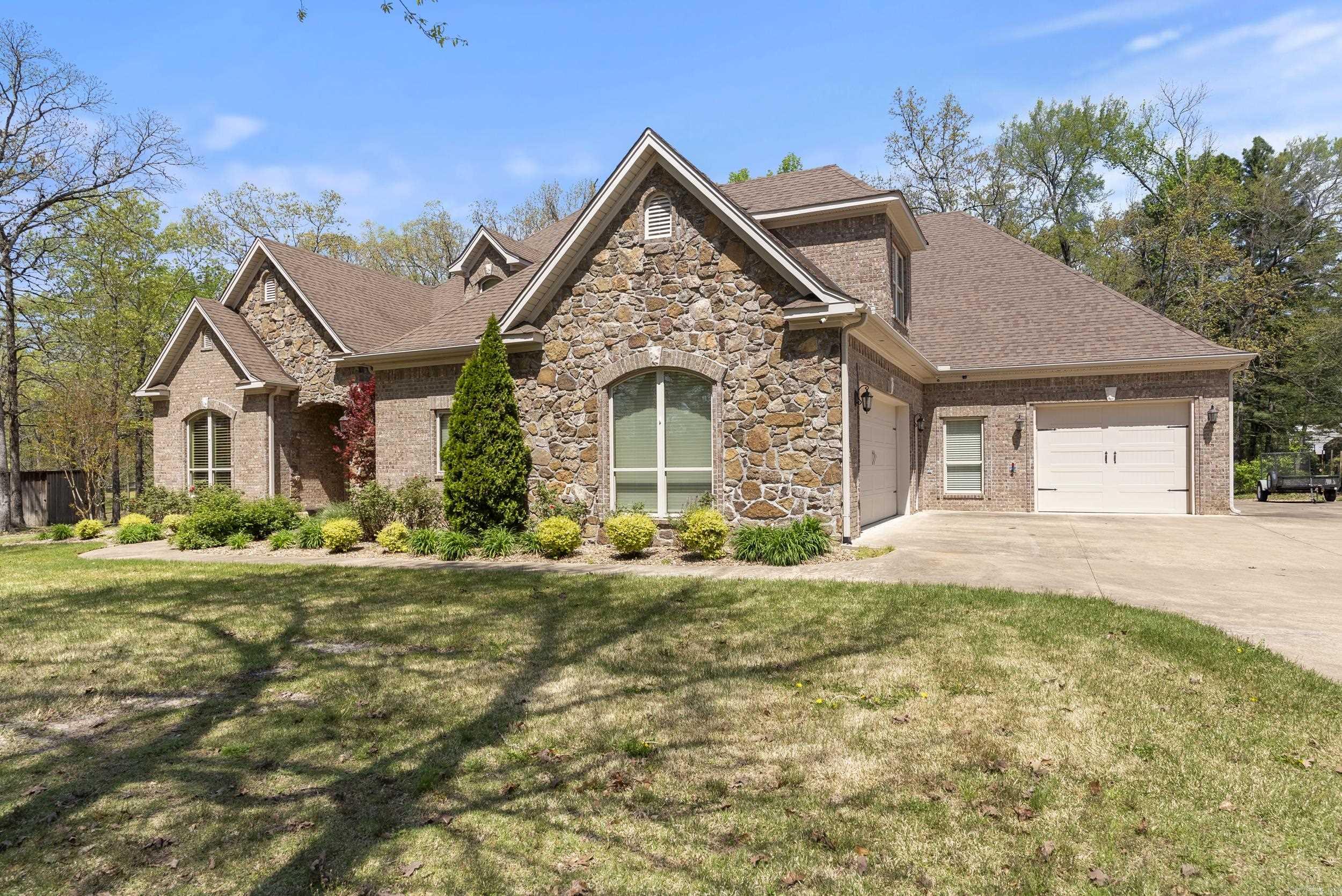 Nestled on two beautifully maintained acres, this stunning 3,726-square-foot home offers a perfect blend of comfort, craftsmanship, and function. Featuring four spacious bedrooms and three and a half baths, the residence includes elegant custom cabinetry, crown molding, and case windows and doors throughout, highlighting the quality and detail found in every corner. A cozy indoor fireplace complements the open living space, while a second fireplace on the covered back porch invites year-round outdoor enjoyment. Designed with entertaining in mind, the home includes a wet bar and a dedicated wine room, perfect for hosting guests. The chefās kitchen flows seamlessly into the main living areas, creating a warm and inviting atmosphere. A secure tornado safe room offers peace of mind during severe weather. The property also includes a 30' x 40' shop, complete with attic storage and a climate-controlled work area powered by a mini split systemāideal for hobbies. An unfinished space upstairs in the home offers the opportunity to add your personal touch, whether as a home office or additional living space. A whole-home generator ensures uninterrupted comfort and convenience.