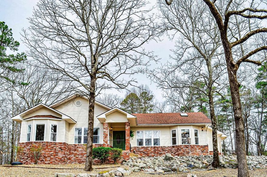 Beautifully Updated home, Walk into the Living room with vaulted ceilings and skylights. Gas log fireplace. Kitchen boasts granite counters and vaulted ceiling with eat-in breakfast area. This home has Hardwood and Tile floors, no carpet! In the living room there is a brand new picture window and New tile in front of the door leading out to a nice level patio. Main bedroom is large and en-suite bathroom with walk-in shower, jetted tub and walk-in closet, granite counters. The 2nd bathroom divides the 2nd bedroom and main, bathroom has a skylight for added light. 3rd bedroom has some built-ins with a desk. Amazing views overlooking the mountains and valley below. Oversized side entry garage which accesses the home through the laundry area. Low maintenance yard. Adjoining lot also comes with this home for added privacy. New windows approx. 5-6 years old. New sewer grinder 2 years ago and new water pressure regulator. Fridge and dishwasher 2022. Air ducts cleaned 3 years ago and added Ultraviolet light in the attic. New Garage door opener 3 years old. New HSV buyers subject to $1,500. buy in fee.