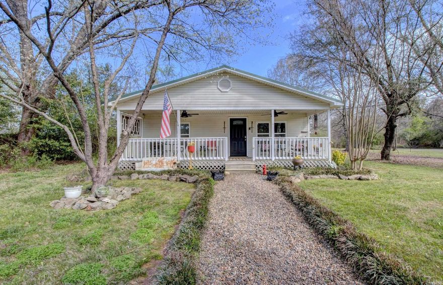 Have you been searching for serenity and peacefulness?  Come tour this CHARMING cottage on almost an acre in Roland. This 2/1 home was taken down to the studs, ceiling raised and beauty was built in 2019 with New Windows, New Doors, Custom Cabinets. HWH 2019 HVAC 2023. Vaulted ceiling in one bedroom/cathedral in other. LVP Floors, Butcher Block counter in kitchen. Fridge conveys. Laundry room with exit to back deck & a spacious pantry cabinet. Every space was well thought out. Sit on the front porch, listen to the birds and the stillness. Grill out on the back deck, listen to some music.  Low maintenance, long lasting metal roof.  Huge yard with mature landscaping (see docs for list), a place for gardening w 2 exterior storage sheds.  Two fire pits can be reached along a river rock pathway to gather and enjoy the beautiful country sky and vista views. Covered parking for two.  12 mins off Chenal Pkwy so close to everything but far enough away from it all. Pinnacle Mountain minutes away! What else could you possibly want?  Hope you will come take a look today!  Click on docs for ALL the detail. See agent remarks.