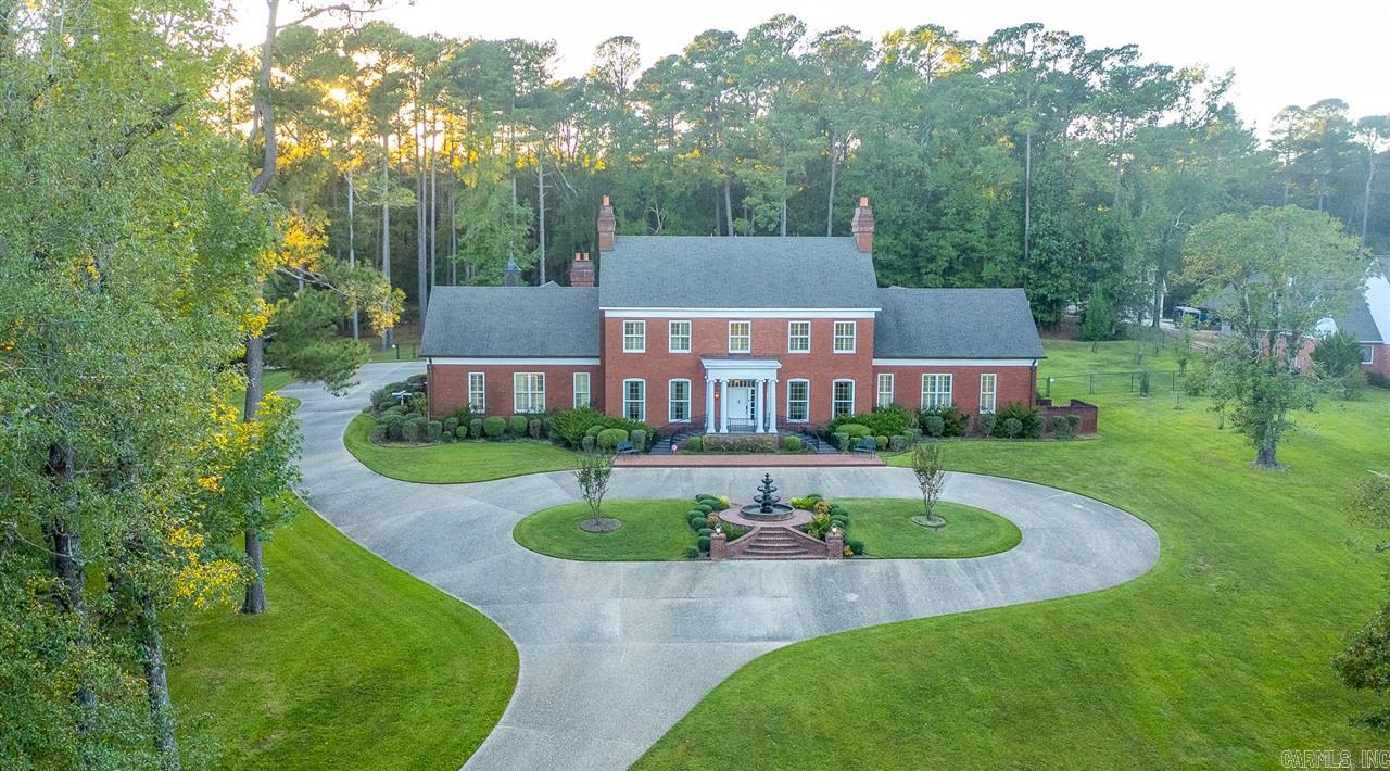 This beautiful, custom built colonial with handmade bricks transported from Williamsport, Maryland was built for entertaining. Sitting on 4.27 well-manicured acres, this home was completed in 2006 by Glenn Owens and professionally designed by TG Conley.    As you enter the foyer, your eyes will be drawn to the crown molding which is wrapped 13 times, a large formal dining room that will sit at least 12 guests and a formal living room with a beautiful marble fireplace. Once exiting the dining room, you will enter the enormous kitchen with all Viking appliances, wet bar with nugget icemaker and a beverage cooler. Tucked away off the kitchen is a cozy den with an abundance of custom built-ins and an 80 inch LED TV over the fireplace. Additionally on the first floor, is the master bedroom with a private sitting room and fireplace, his and her bathrooms each with walk-in closets. You will also find an office, workout/ playroom and a powder room on this wing of the home. As you make your way upstairs, there is a cedar lined closet, an additional master suite with marble fireplace and full bathroom, as well 2 other bedrooms with en suites.    Notable amenities include custom drapes and pl