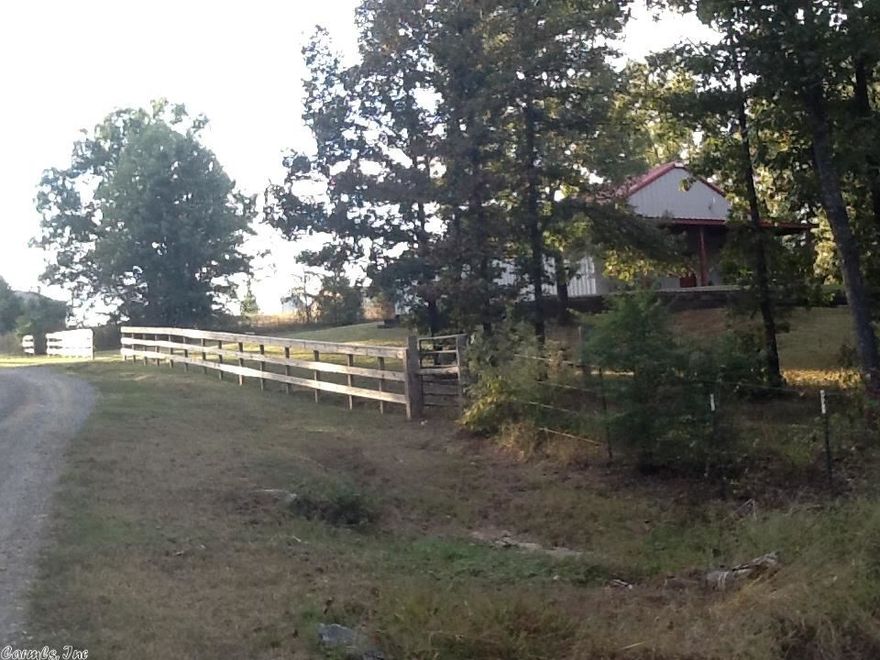 SERENITY AT ITS BEST!   This 40x60 metal building has been made to be a beautiful home.  1400 s/f of just beautiful living space.  Has large walkin shower, also has claw foot bath tub just off master suite.  Has huge laundry room.  Open floor plan with eat in kitchen, stainless appliances, oak cabinets, wood & tile floors.  9ft ceilings Bedrooms are very nice sized with nice closet space.  Covered front porch overlooks land and pond.  Very nice 40xx20 garage/shop area.  Fenced for horses or cows.