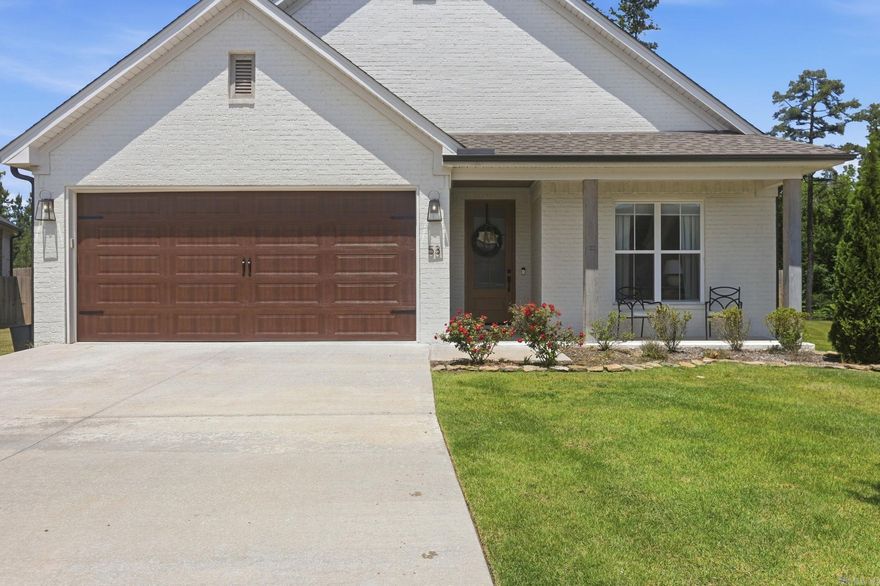 Surrounded by lush landscaping and mature trees, this home sits on a corner lot with a massive backyard. Notably, landscaping services are included in the annual dues. This single-level home features three bedrooms and two full bathrooms with a functional, stylish layout. The primary suite serves as a sanctuary, featuring a soaking tub, an oversized walk-in shower, and an expansive custom closet.  Designer-curated finishes and superior craftsmanship are evident throughout the property. The open-concept design is perfect for entertaining and includes a chef’s kitchen with quartz countertops and custom cabinetry. Additionally, the home offers a large, covered patio for outdoor living.