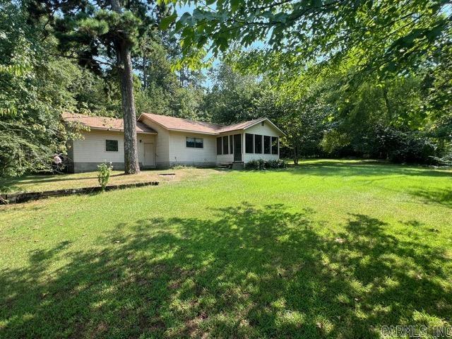 Although close to the highway, this property is private, surrounded by woods. The cozy bungalow, having 1 bedroom and 1 bathroom, has a perfect floor plan that maximizes small space living. It features a large garage, laundry room with a sink, and an open floor plan. The screened-in porch is spacious and beckons you to enjoy the outdoors, free from pests. The AC unit was recently replaced in 2025. A new roof in 2021. ADA accessible.