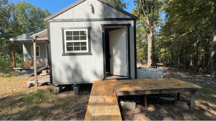 2 unrestricted acres m/l with two Derksen buildings, that need a few finishing touches. This property is only one mile from the marina.