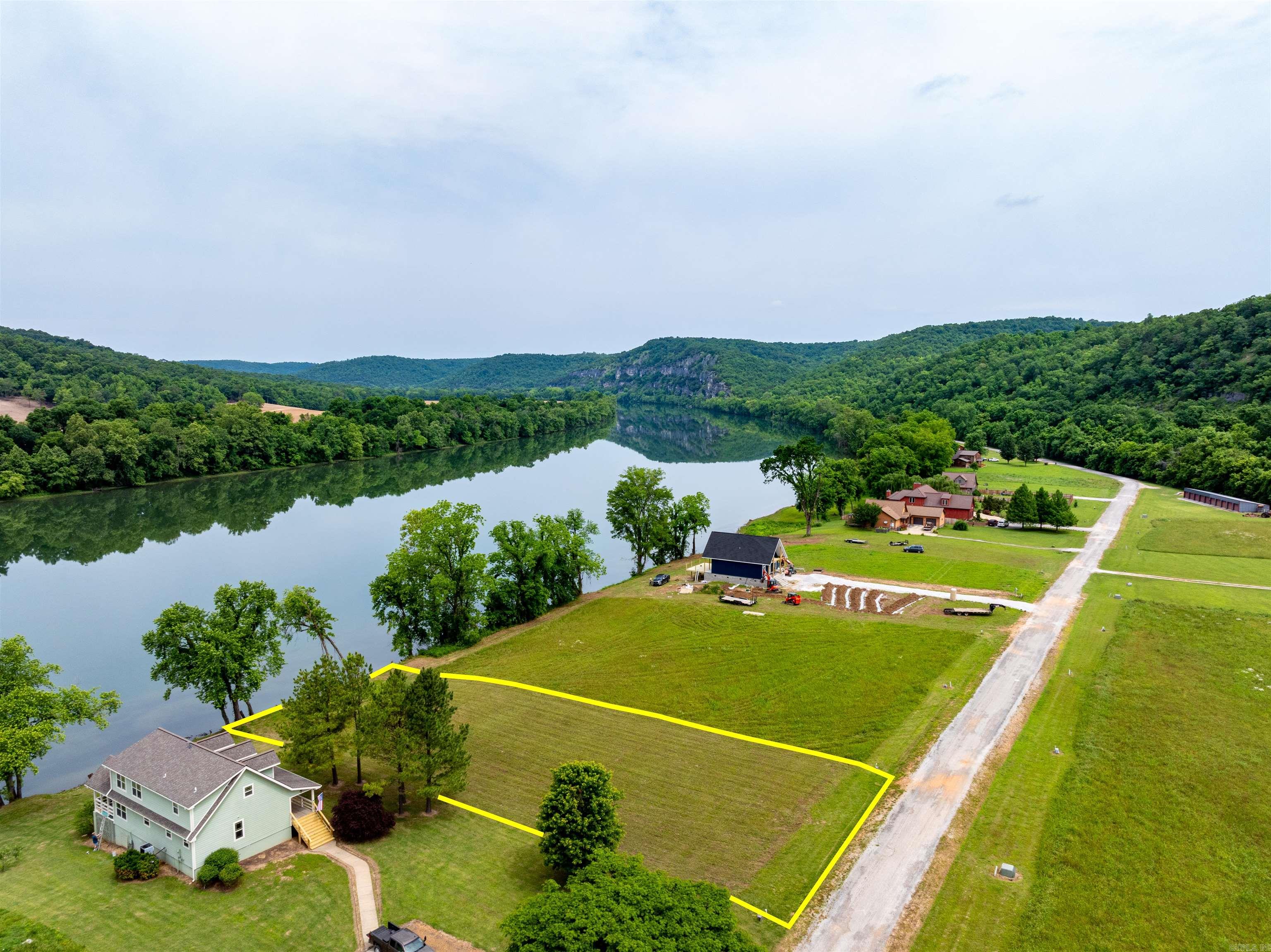 Experience the Pristine Beauty of the Ozark Mountains and White River from Your Own Waterfront Haven!Lot 25 of the Collietown Subdivision offers a rare opportunity to own a meticulously manicured slice of the Ozark Mountains, preserving a few select trees to enhance its natural charm.Situated just inside the subdivision, this half-acre lot gently slopes from the road down to the breathtaking White River, providing the perfect setting for your dream home.With underground utilities, including electricity and water, available at the road, all you need is a septic system to start building your riverside retreat.The White River is renowned worldwide for its excellent trout and smallmouth bass fishing,making this location a paradise for anglers and nature lovers alike.The views from Lot 25 is unparalleled, with the famous Painter's Bluff, a stunning natural feature of the Ozark Mountains, visible right from your property.As a property owner within the gated Collietown Subdivision, you'll enjoy exclusive access to a shared boat launch, making it easy to explore and enjoy the river.Additionally, storage units are available for rent, and a storm cellar is available during inclement weather.