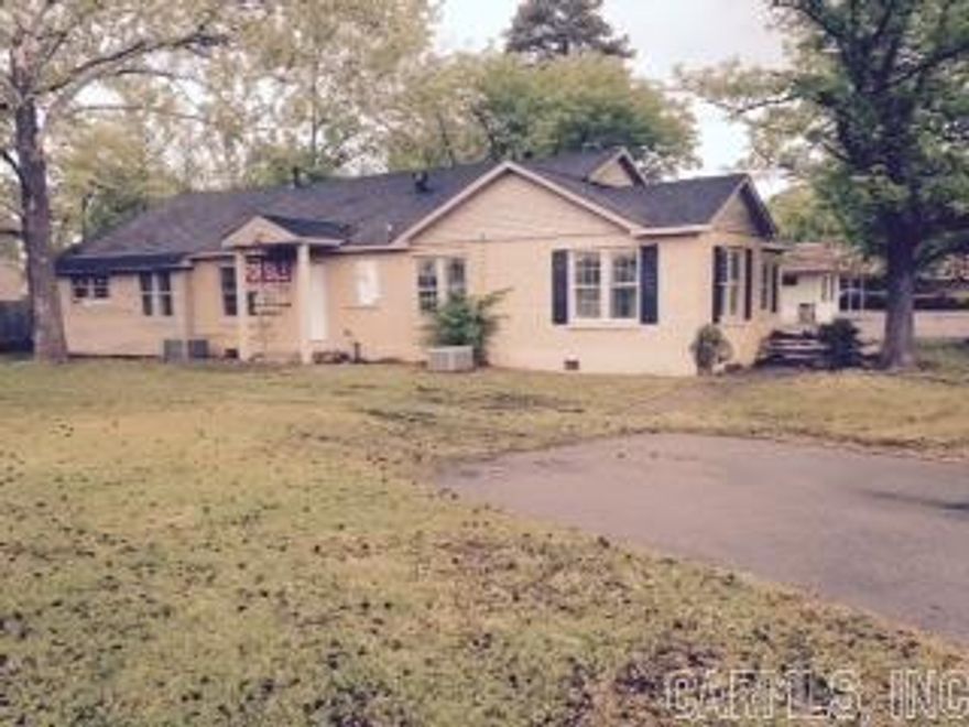 Was recently a duplex and was partially redone. Mostly new paint and windows inside and some fixtures. Floors are not done and bathrooms and kitchens are in the rough. Would be great for duplex again, or would be great to have as 2 office suites each with own entrance! Could also be commercial. Has central heat and air, but not sure if they work. Sold "as is" at this price.Includare building materials there--hardwood, tile paint, sinks etc;  Can live in one side and office in other! See Agent Remarks & Docs