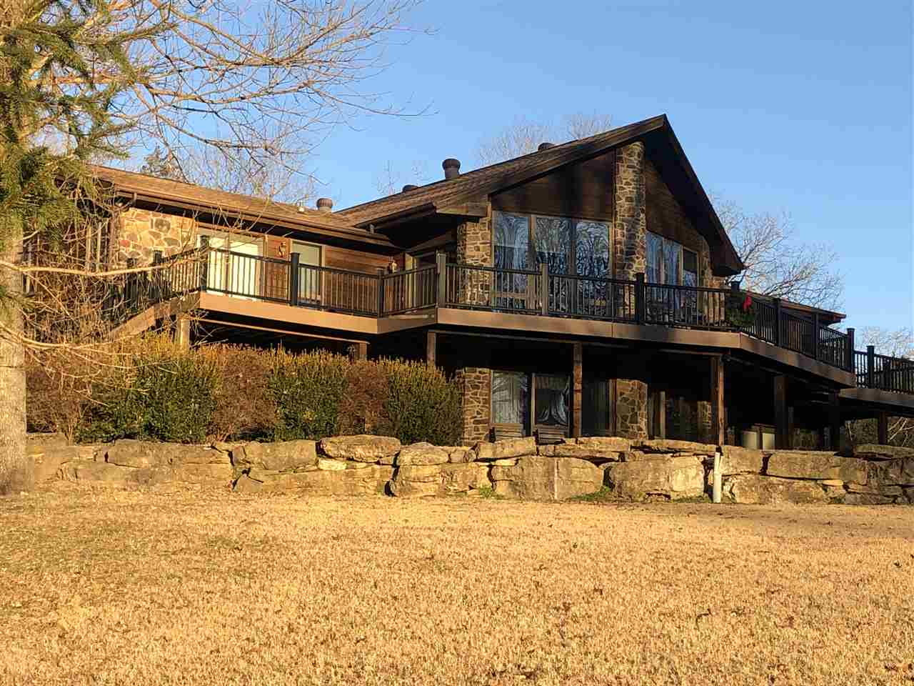 PRICE REDUCED on Custom 4,700 SqFt, 4-bed, 4-bath luxury home overlooking 300' of White River on 10.3 acres. 2-slip (4-boat) boat dock with lift on White River conveys with property. Built as a B&B, the home features a chefs kitchen with high-end appliances, 2 stone fireplaces, Terracotta tile and hardwood floors (no carpet), each bedroom with private bath and outside deck access, new roof, geothermal heating and cooling, and separate large shop. Beautiful river views. Mineral rights convey. Priced to sell!