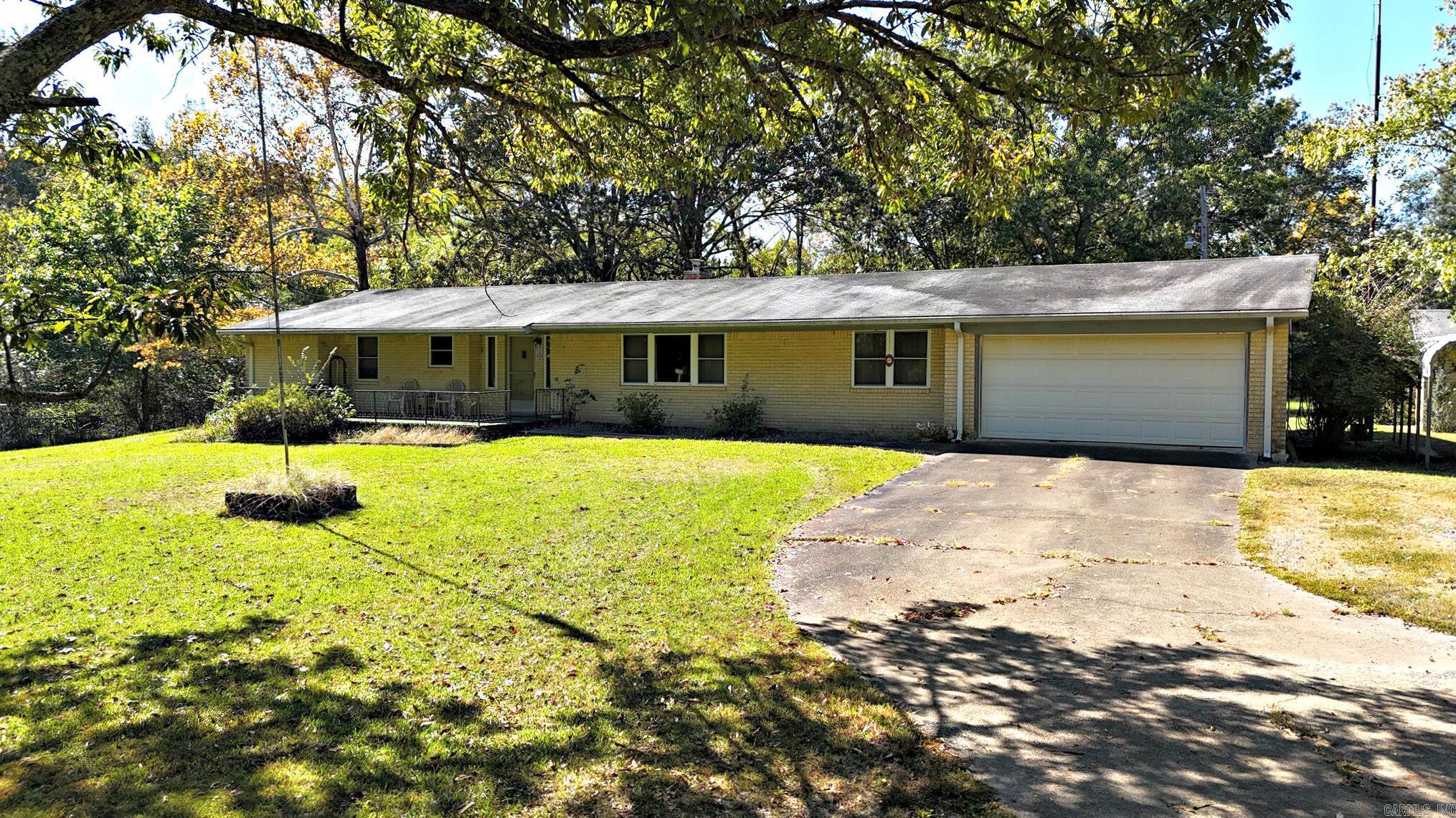 Just minutes from Mena and the many outdoor assets of the Ouachita Mountains, this 3-bed/3-bath brick home offers 2,403 sq ft of living space in an appealing layout. The third bedroom makes a perfect home office, and the separate dining/living room combo adds flexibility. A brand-new HVAC system ensures modern comfort in the midst of this older-brick charmer. With large, inviting rooms, a screened sun porch overlooking the property. Outside, the property truly shines. The gorgeous yard is surrounded by a mix of open pasture and mature timber, with several outbuildings, a barn, and a small pond adding to its charm and functionality. Meandering trails wind through the property, offering great opportunities for walking, ATV rides, horseback adventures, or simply exploring nature right in your own backyard. It’s an ideal setting for those who enjoy hunting, recreation, or a self-sustaining homestead lifestyle. Located in Polk County near Lake Wilhelmina and Queen Wilhelmina State Park, you’re never far from trails, water and scenic drives, yet you return home to your own tranquil haven.