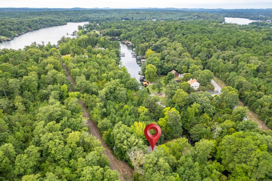 Investment opportunity to own charming retreat on a creek bed that opens up to the main channel of Lake Hamilton.
