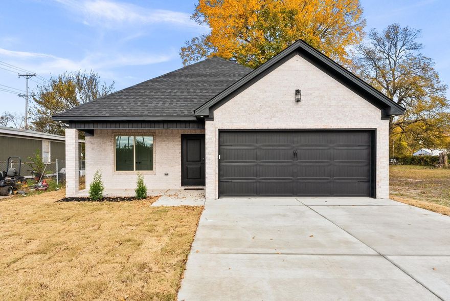 Beautiful antiqued all-brick, maintenance-free home featuring dark soffit and fascia accents, landscaping, and a 15’ x 6’ covered brick porch with wood-lined ceiling and under-eave lighting. The front entry hall offers wide-plank flooring, crown trim, and recessed lighting. Front bedroom (11’2” x 9’5”) includes a double-door closet with built-ins and a large picture window. Hall bath features a granite vanity, deep linen closet, and tub/shower combo. Second bedroom (12’ x 11’2”) offers crown trim, recessed lighting, and built-ins. The master suite (13’9” x 12’2”) includes two windows, a 6’ x 5’9” walk-in closet, and a bath with granite vanity, black bronze fixtures, and a custom tile walk-in shower. The kitchen features granite counters, custom cabinetry, tile backsplash, Whirlpool appliances, counter-bar seating, and a 6’ x 3’ pantry. Living area (19’ x 13’3”) includes built-ins, recessed lighting, and backyard access. Exterior features include an 8’6” x 6’7” patio and large privacy-fenced yard with walk-thru gate.
