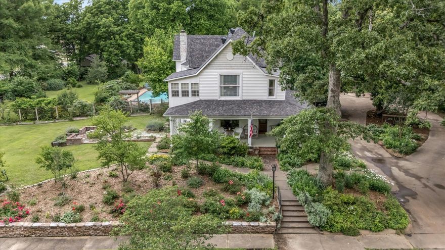 Timeless Charm Meets Modern Luxury on 2 Acres in the Heart of Jonesboro. Step into a piece of history with this stunning 5-bedroom, 4.5-bath single-family estate, originally built in 1905 and thoughtfully renovated to blend classic charm with exceptional modern amenities. Situated on a sprawling 2-acre lot in the heart of Jonesboro, this one-of-a-kind home offers the perfect balance of privacy, comfort, and character and has only had three owners in its storied history. Inside, the home features beautifully updated living spaces that retain the warmth and craftsmanship of a bygone era. Large windows fill each room with natural light, enhancing the inviting atmosphere throughout. The layout is spacious and functional, ideal for both everyday family living and entertaining. Old-world charm is on full display, from the grand front stairway to the secondary back staircase both offering a glimpse into the home's rich history. Don't miss the whimsical powder room tucked beneath the stairs, a delightful nod to the home's unique personality. Step outside to enjoy multiple large covered porches, perfect for sipping coffee, relaxing in the shade, or hosting guests year-round.