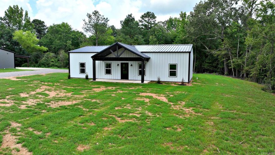 This brand new 3-bedroom, 2-bathroom home offers 1,800 square feet of thoughtfully designed living space. Featuring an open floor plan with spacious rooms, this home is perfect for a variety of lifestyles. The interior showcases granite countertops throughout, soft-close cabinet doors, and quality finishes. The primary bathroom includes dual vanities, a walk-in tile shower, and a large walk-in closet, providing both comfort and functionality. Built with durability and efficiency in mind, the home includes double wall insulation, metal siding, and a metal roof—making it a low-maintenance option for any homeowner. An oversized two-car carport and a large 6' x 50' porch add to the convenience and outdoor enjoyment of the property. This home also offers access to nearby ATV and bike trails, making it a great fit for those who enjoy outdoor activities. Whether you're looking for a full-time residence or an investment opportunity, this property combines modern amenities with a practical layout to suit a wide range of needs. All buyers are welcome to explore what this unique home has to offer.  Taxes must be accessed for accuracy.