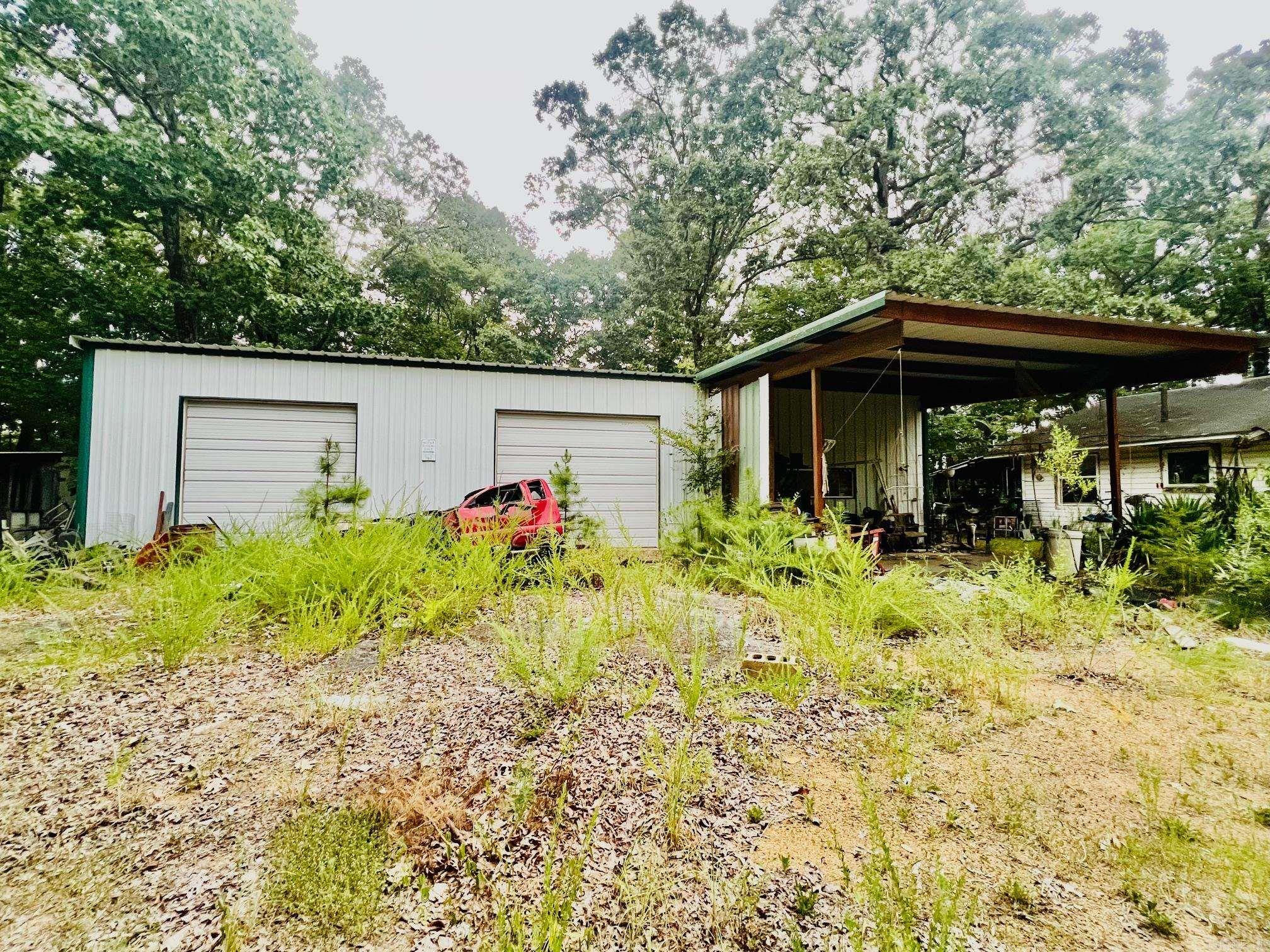 No Value on home. 9 wooded acres with Hwy 71 frontage. Large shop with lift. Electric, well, septic on property. Mountain view to the SW. Owner to remove items from shop prior to closing. Property sold "AS IS". Well and septic were in normal working order when home was occupied.